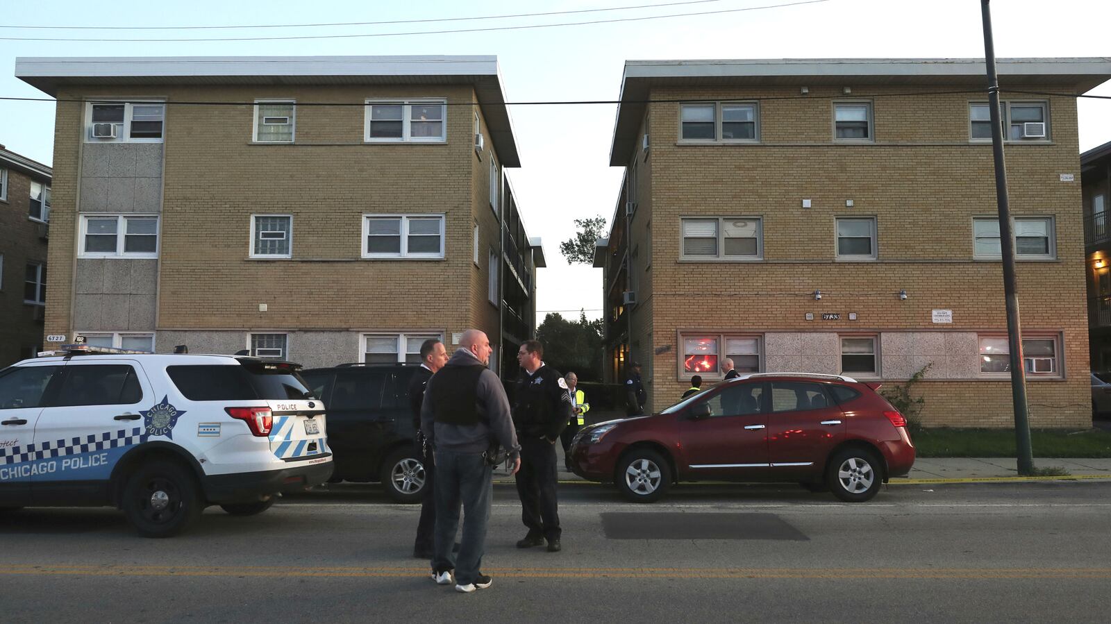 Chicago police officers are pictured outside a condominium complex where five people were killed Saturday, Oct. 12, 2019. Krysztof Marek, 66, has been charged with five counts of first-degree murder in the shooting, which targeted his neighbors.