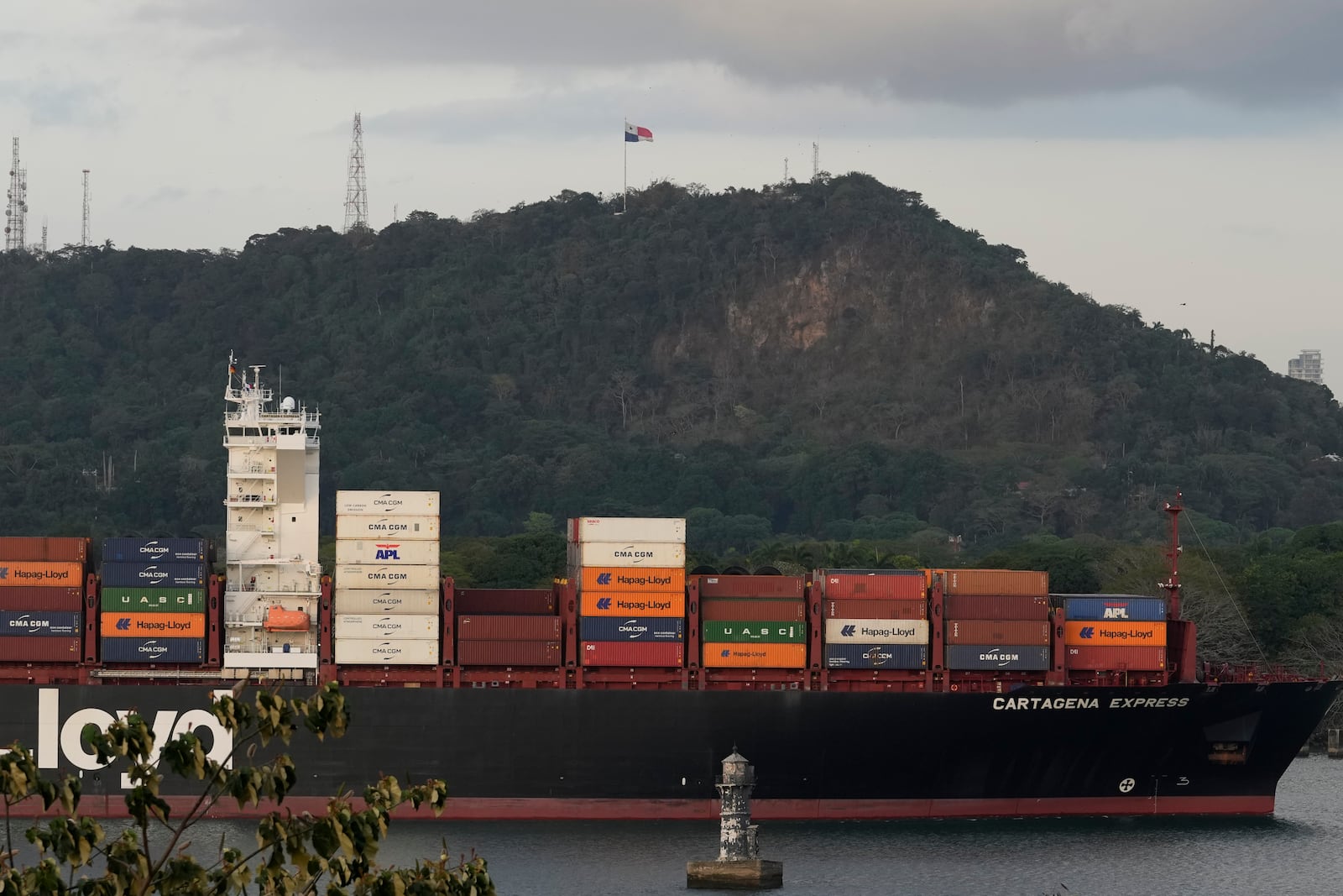 A cargo ship sails past the Panama Canal's Port of Balboa in Panama City, Thursday, March 13, 2025. (AP Photo/Matias Delacroix)