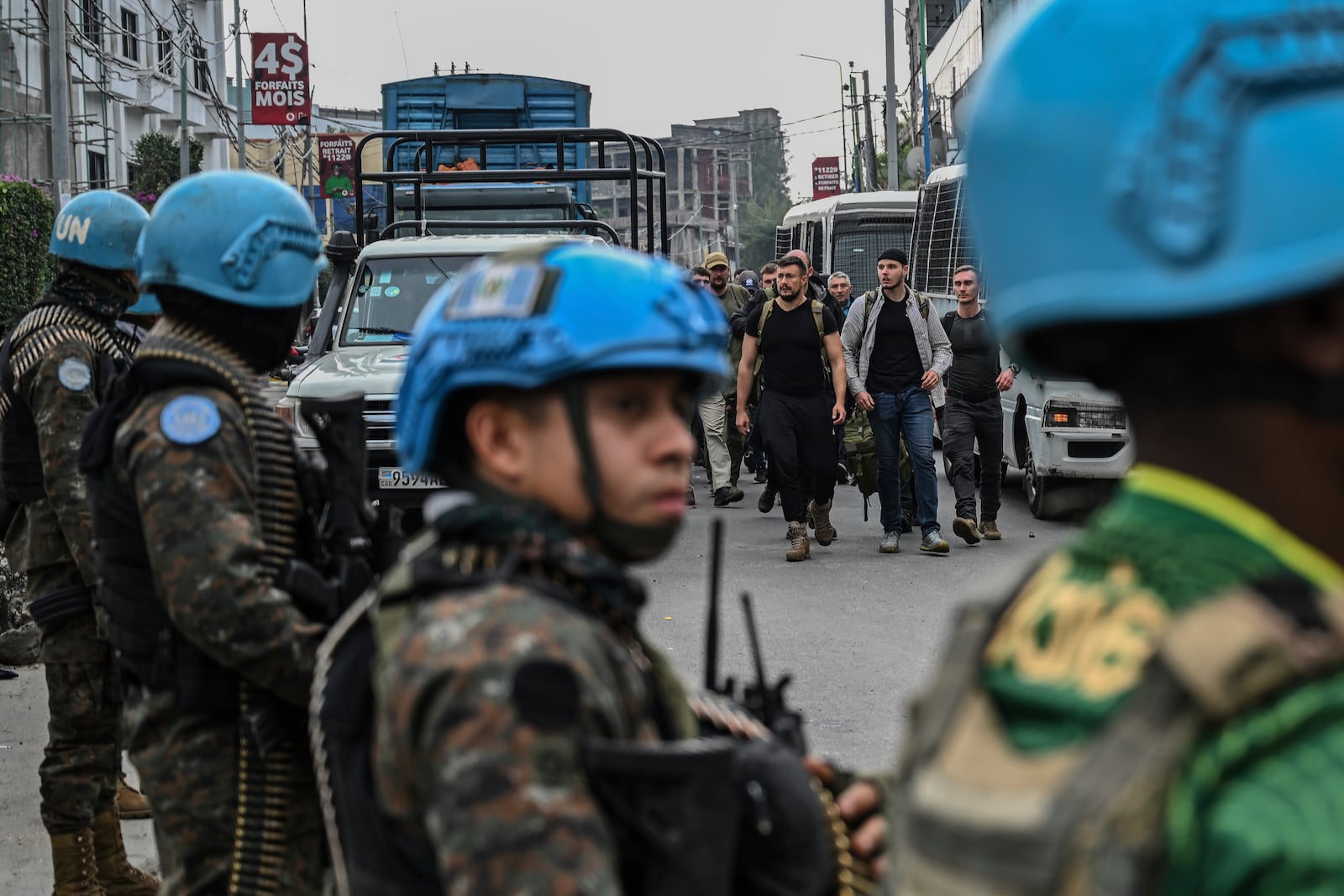 M23 rebels escort Romanian mercenaries past UN peacekeepers to the border crossing into Rwanda in Goma, Democratic Republic of Congo, Wednesday, Jan. 29, 2025.(AP Photo/Moses Sawasawa)