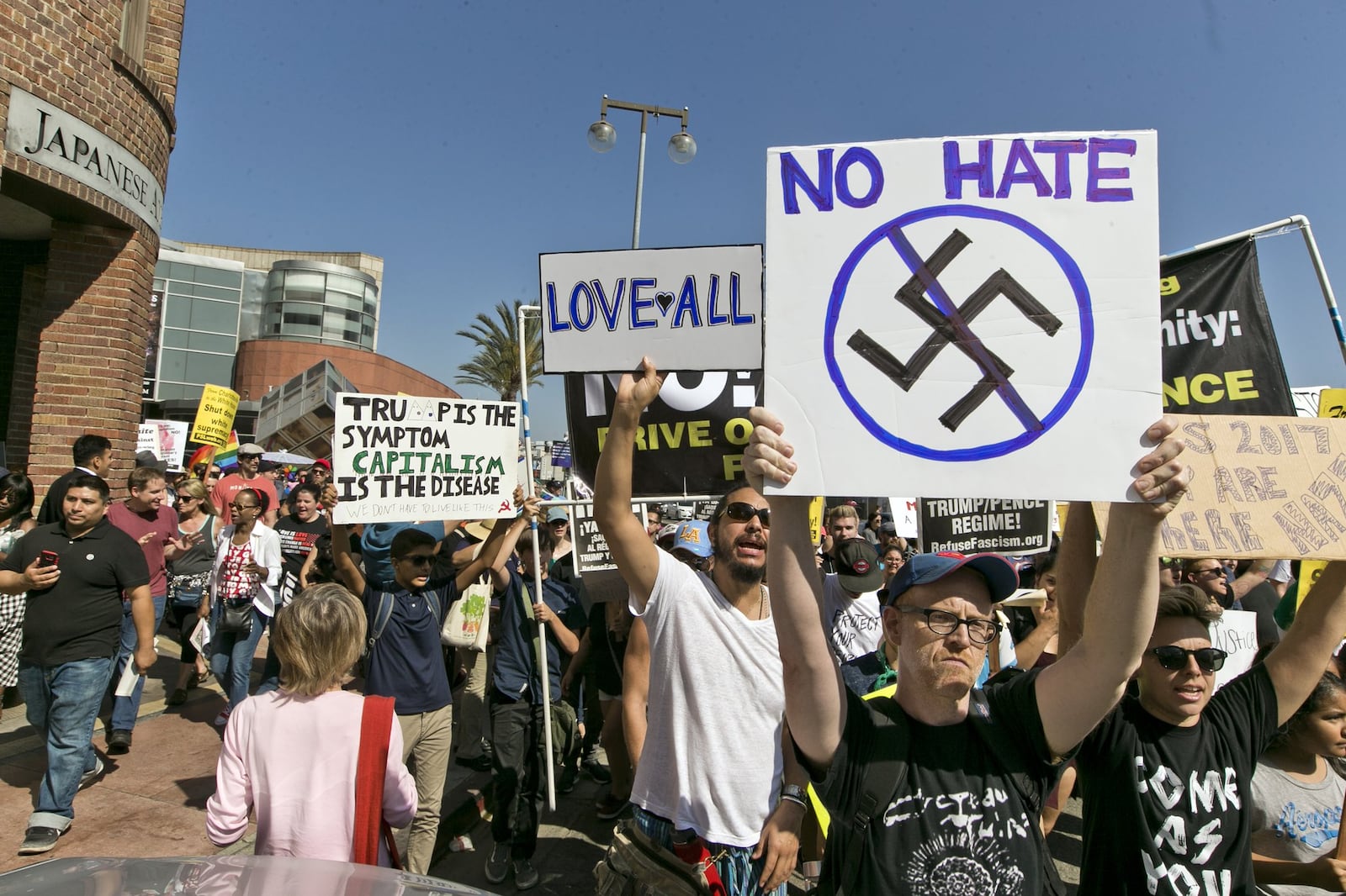 In this Aug. 13, 2017, file photo, demonstrators march in downtown Los Angeles decrying hatred and racism the day after a white supremacist rally that spiraled into violence in Charlottesville, Va. A monument at Hollywood Forever Cemetery commemorating Confederate veterans has been taken down after hundreds of people demanded its removal. (AP Photo/Damian Dovarganes, file)