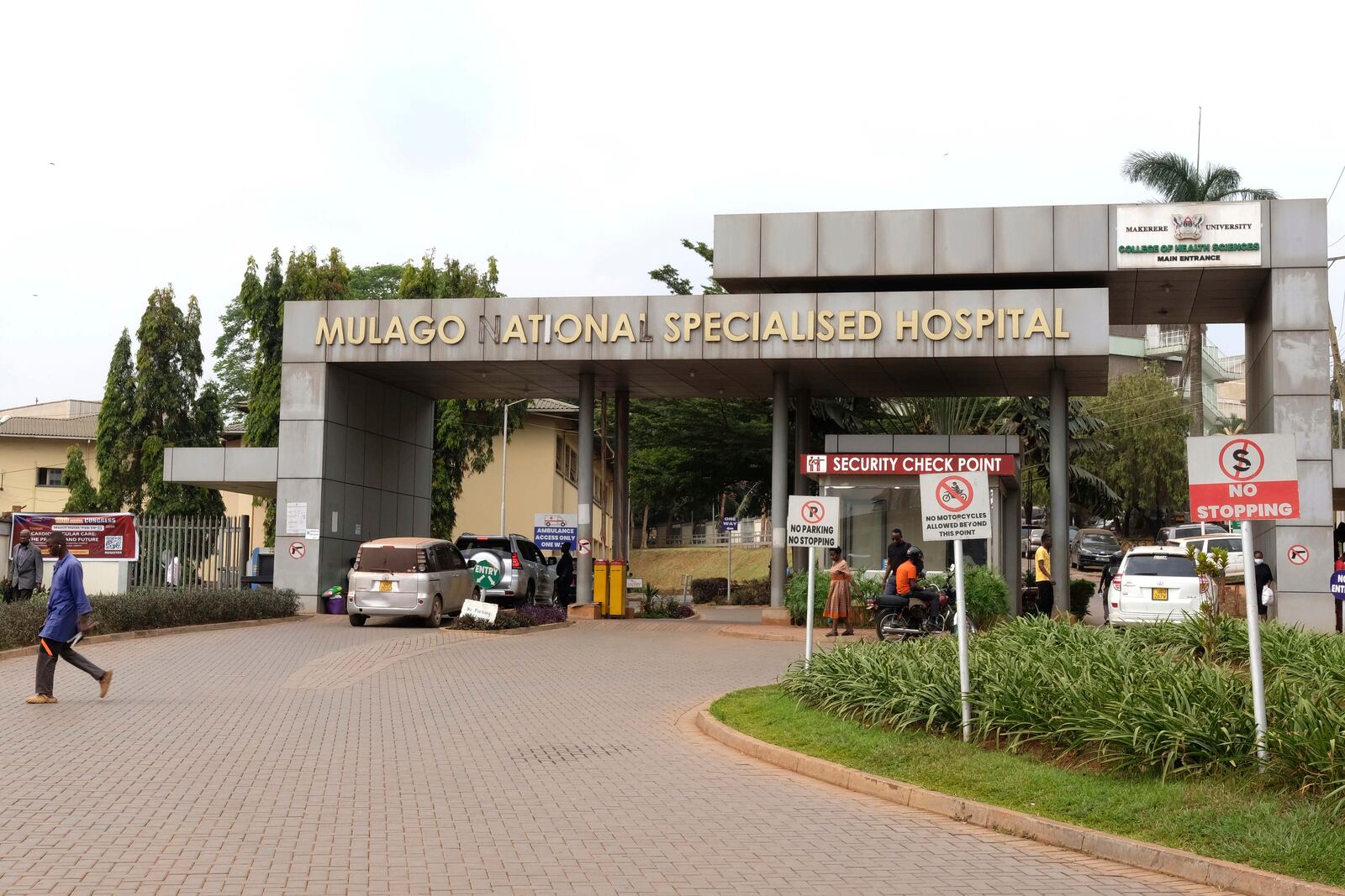 People walk outside the Mulago National Hospital in Kampala, Uganda, Thursday, Jan, 30, 2024, where a nurse had died of Ebola. (AP Photo/Hajarah Nalwadda )