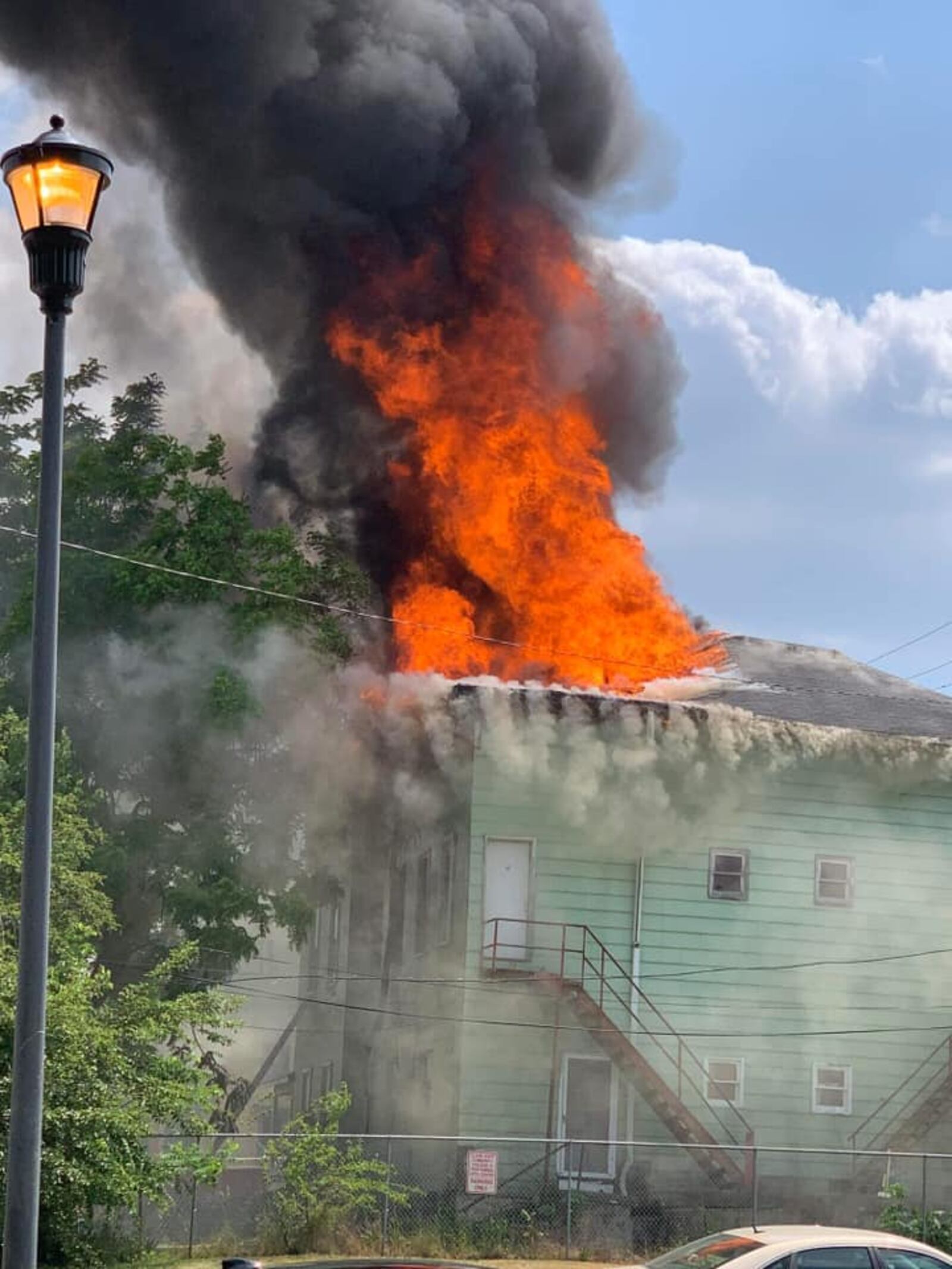 Flames shoot through the roof in a house fire on East Mulberry Street in Springfield on Friday, June 9, 2023. EMILY PARSONS/CONTRIBUTED