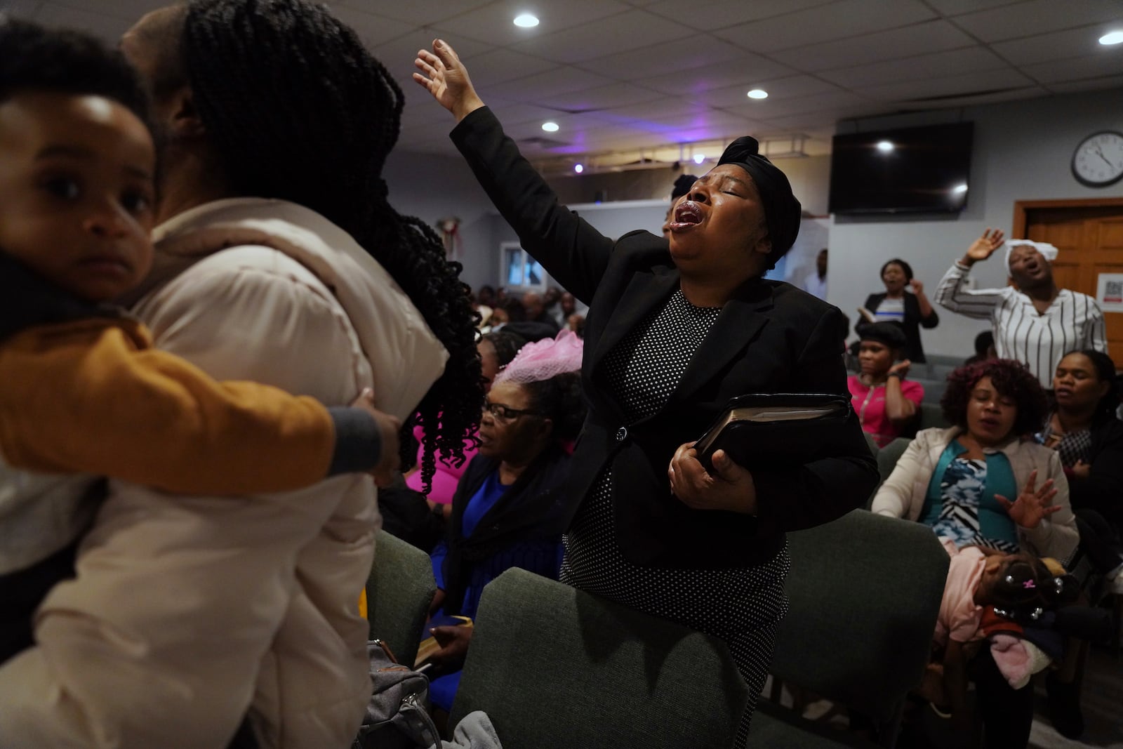 Matana Picard Merceus worships with Rolando Sumeus and her son, left, and other congregants at the First Haitian Evangelical Church of Springfield, Sunday, January 26, 2025, in Springfield, Ohio. (AP Photo/Jessie Wardarski)