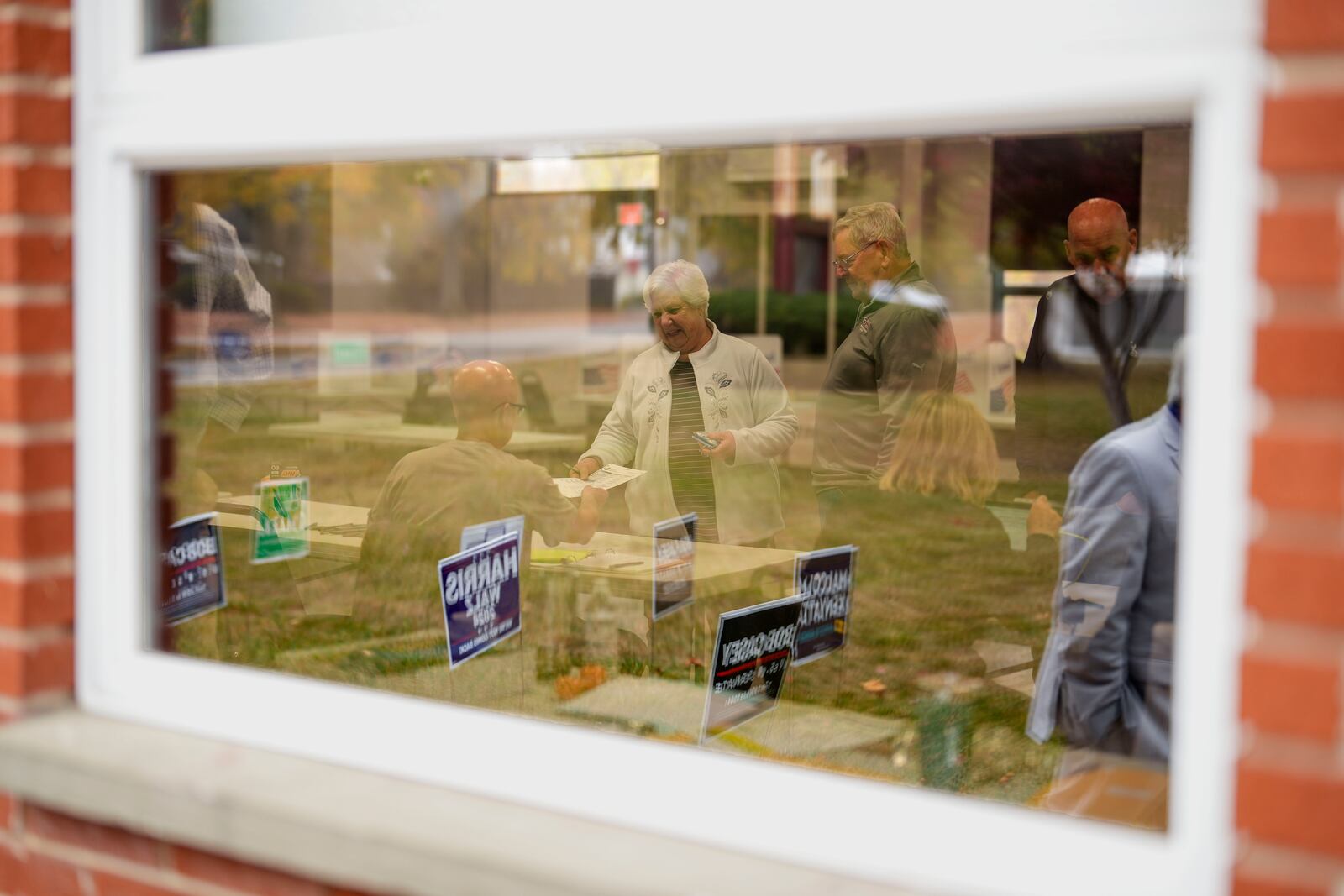 Voters receive their ballots at a polling place, Tuesday, Nov. 5, 2024, in Springfield, Pa. (AP Photo/Matt Slocum)