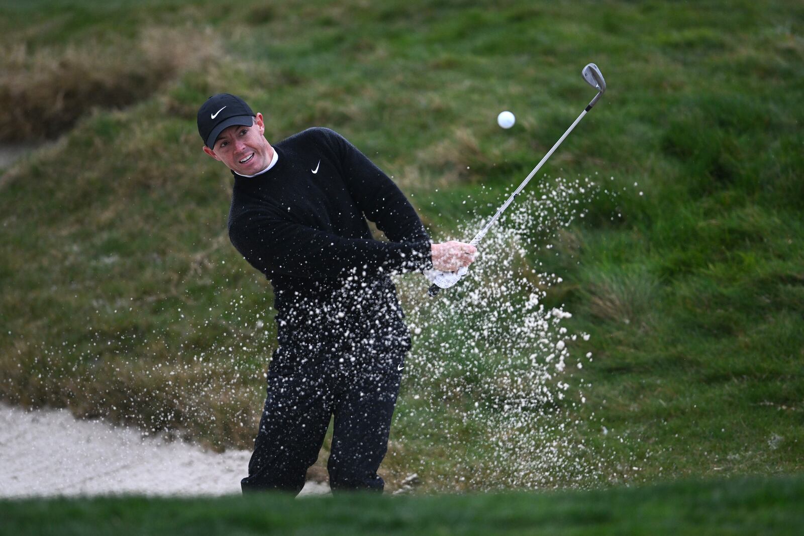 Rory McIlroy, of Northern Ireland, watches his bunker shot on the 17th hole at Pebble Beach Golf Links during the third round of the AT&T Pebble Beach Pro-Am golf tournament, Saturday, Feb. 1, 2025, in Pebble Beach, Calif. (AP Photo/Nic Coury)