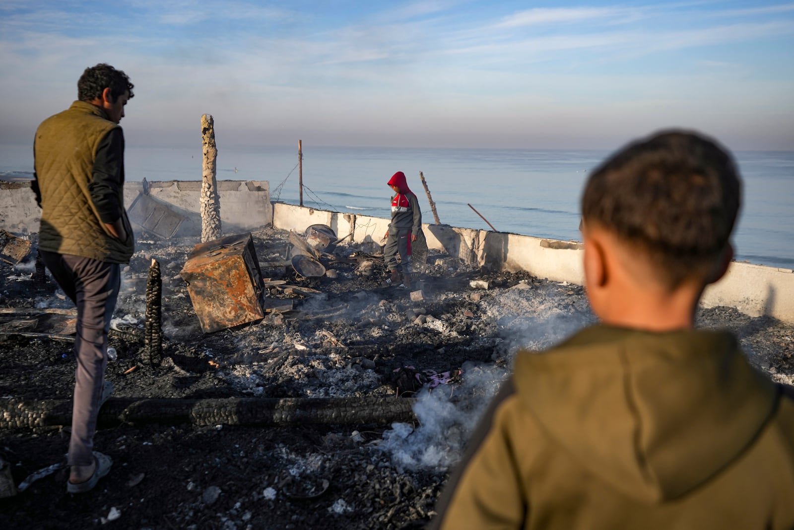 Palestinians inspect the site of an Israeli army strike early Tuesday morning in Deir Al-Balah in the central Gaza Strip, Tuesday, Jan. 14, 2025. (AP Photo/Abdel Kareem Hana)