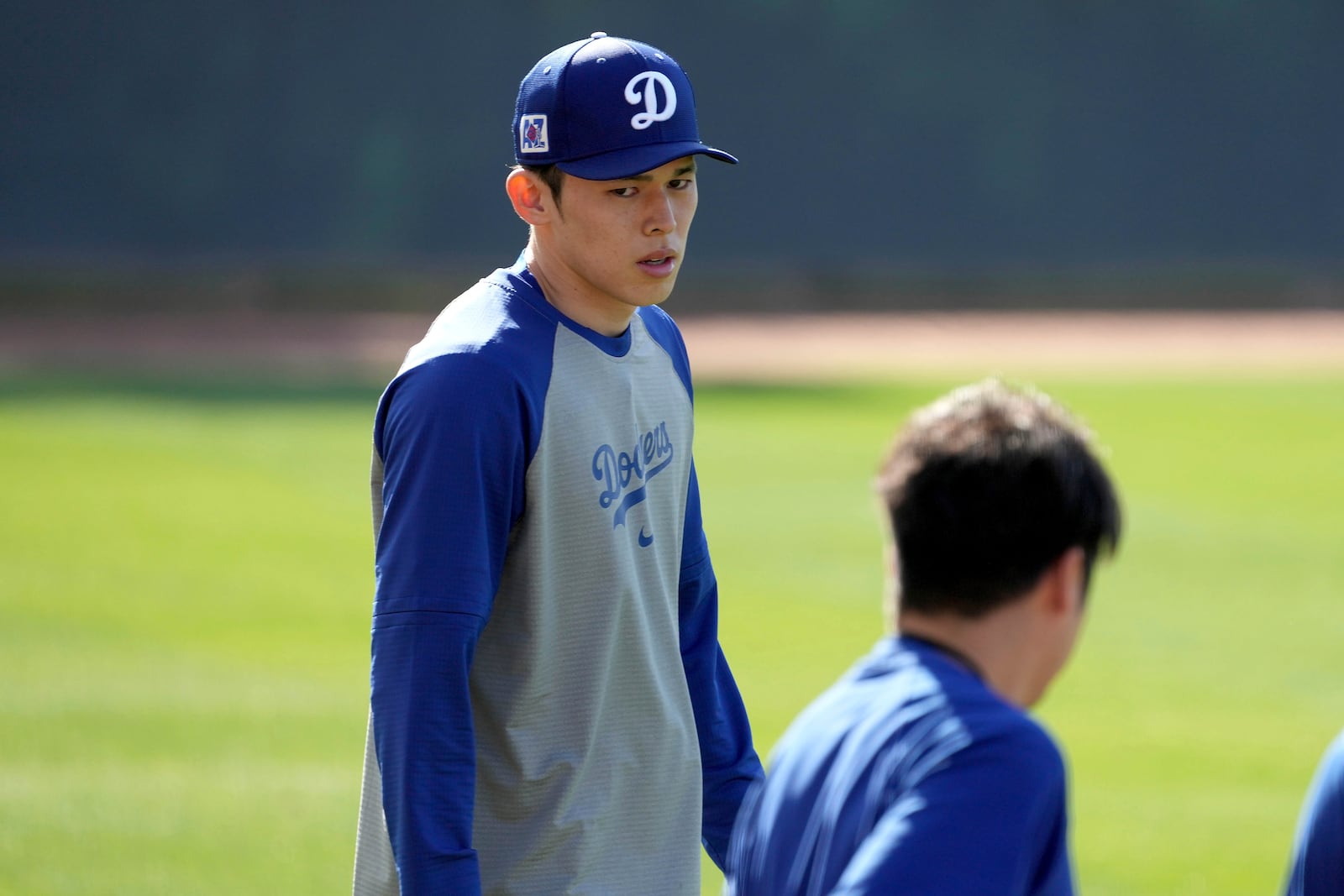 Los Angeles Dodgers pitcher Roki Sasaki warms up before his first live bullpen session during spring training baseball practice, Wednesday, Feb. 19, 2025, in Phoenix. (AP Photo/Darryl Webb)