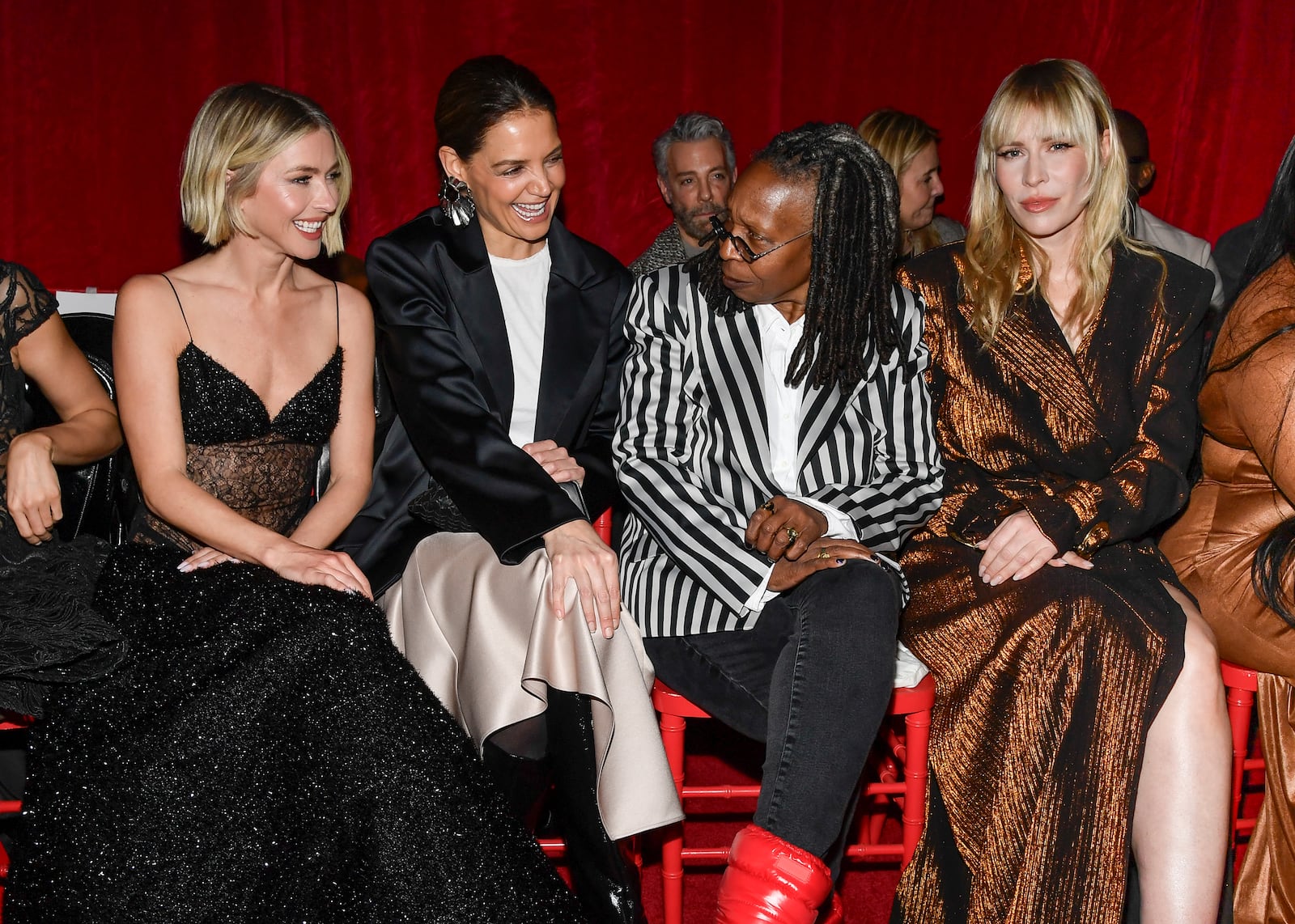 Julianne Hough, from left, Katie Holmes, Whoopi Goldberg and Natasha Bedingfield attend the Christian Siriano Fall/Winter 2025 fashion show at Chelsea Industrial during New York Fashion Week on Thursday, Feb. 6, 2025, in New York. (Photo by Evan Agostini/Invision/AP)