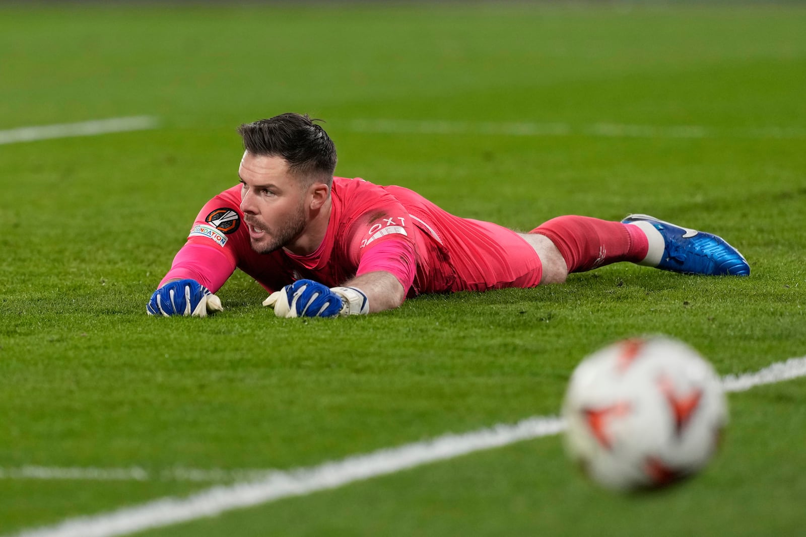 Rangers' goalkeeper Jack Butland makes a save during the Europa League round of 16 first leg soccer match between Fenerbahce and Rangers at Sukru Saracoglu stadium in Istanbul, Turkey, Thursday, March 6, 2025. (AP Photo/Khalil Hamra)