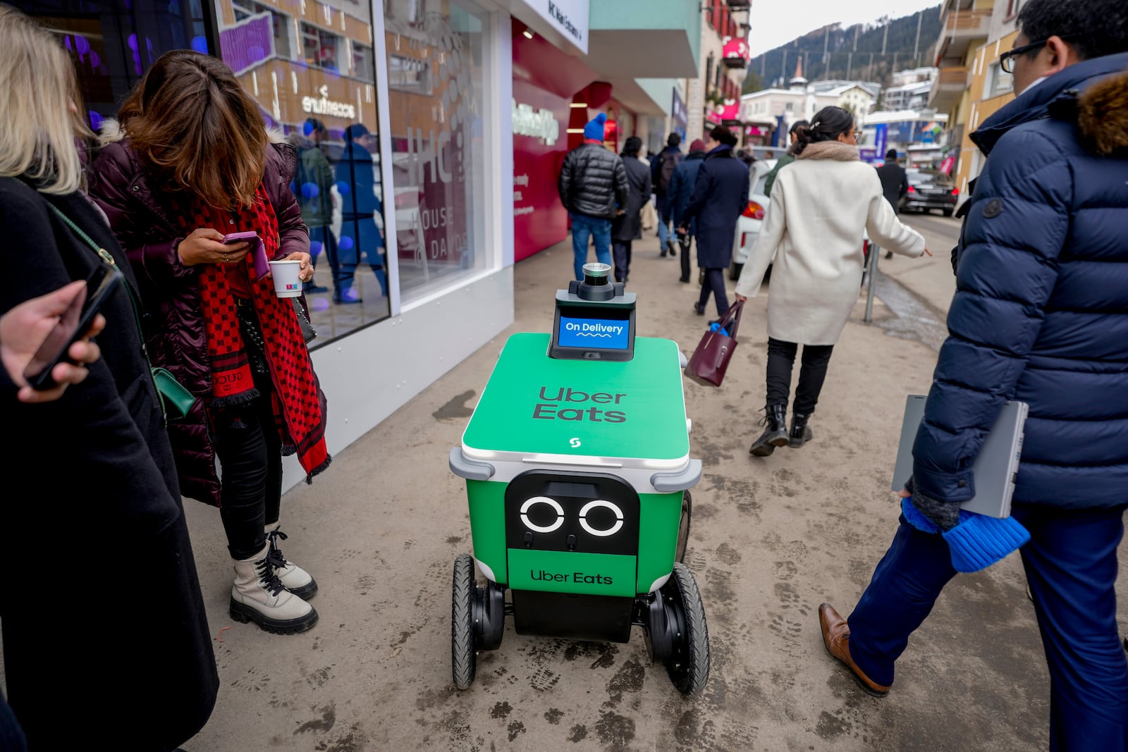 An autonomous food delivery vehicle serves people during the Annual Meeting of World Economic Forum in Davos, Switzerland, Wednesday, Jan. 22, 2025. (AP Photo/Markus Schreiber)