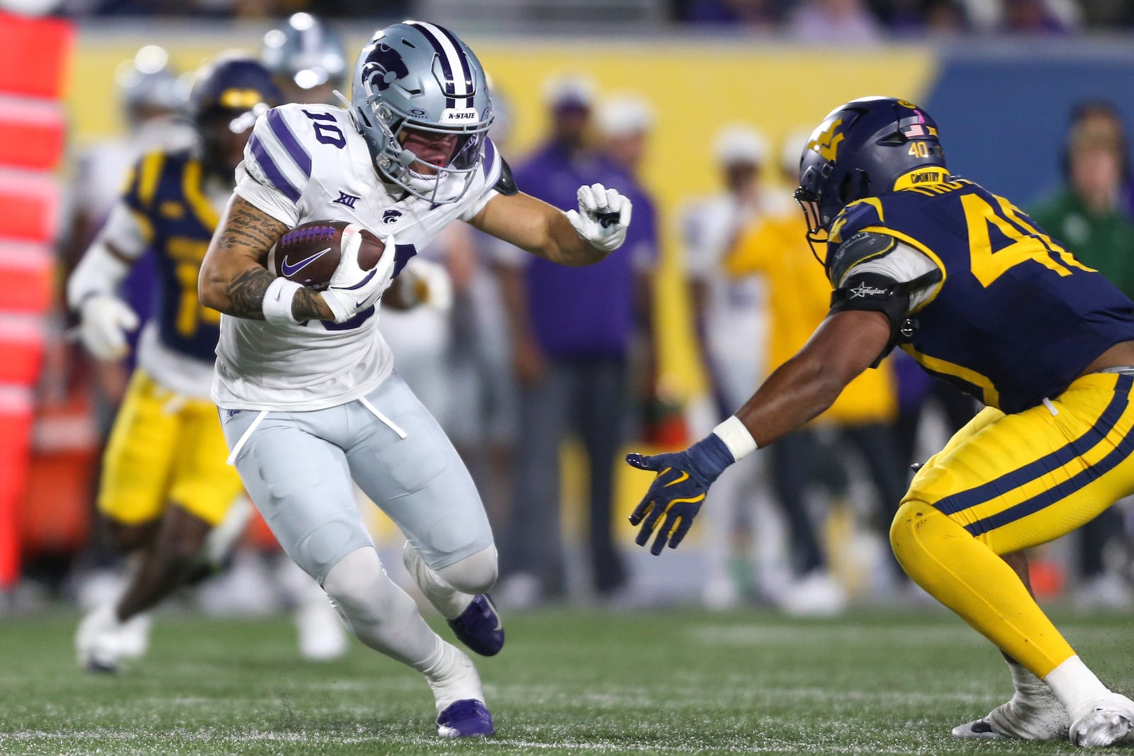 Kansas State wide receiver Keagan Johnson (10) is tackled b West Virginia linebacker Josiah Trotter (40) during the frist half of an NCAA college football game, Saturday, Oct. 19, 2024, in Morgantown, W.Va. (AP Photo/William Wotring)