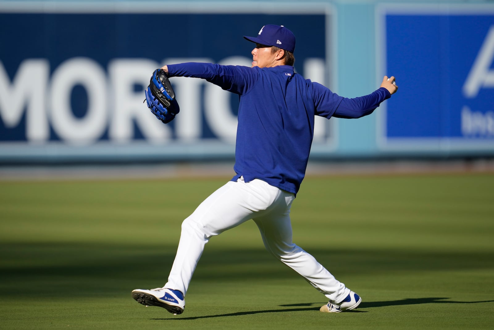 Los Angeles Dodgers pitcher Yoshinobu Yamamoto throws on the field ahead of Game 5 of a baseball NL Division Series between the Los Angeles Dodgers and the San Diego Padres, Thursday, Oct. 10, 2024, in Los Angeles. (AP Photo/Ashley Landis)