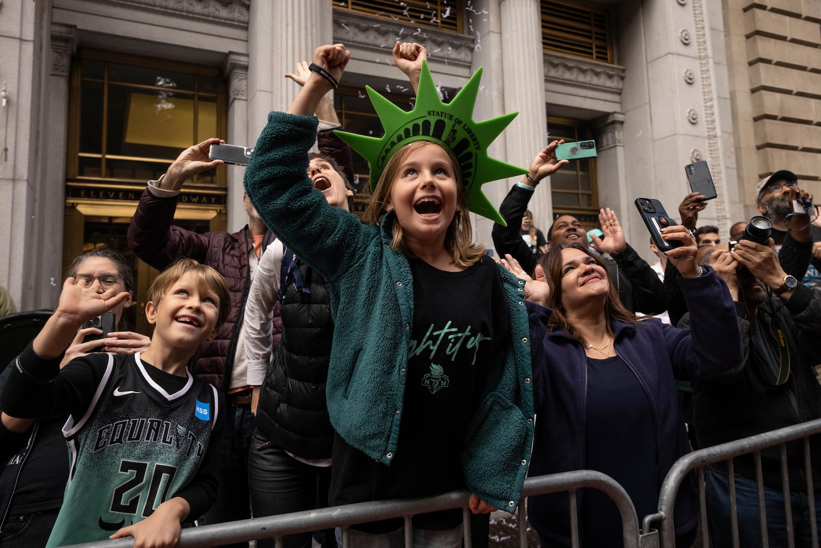 Spectators react as a float with members of the New York Liberty make its way up Broadway during the WNBA basketball championship parade Thursday, Oct. 24, 2024, in New York. (AP Photo/Yuki Iwamura)