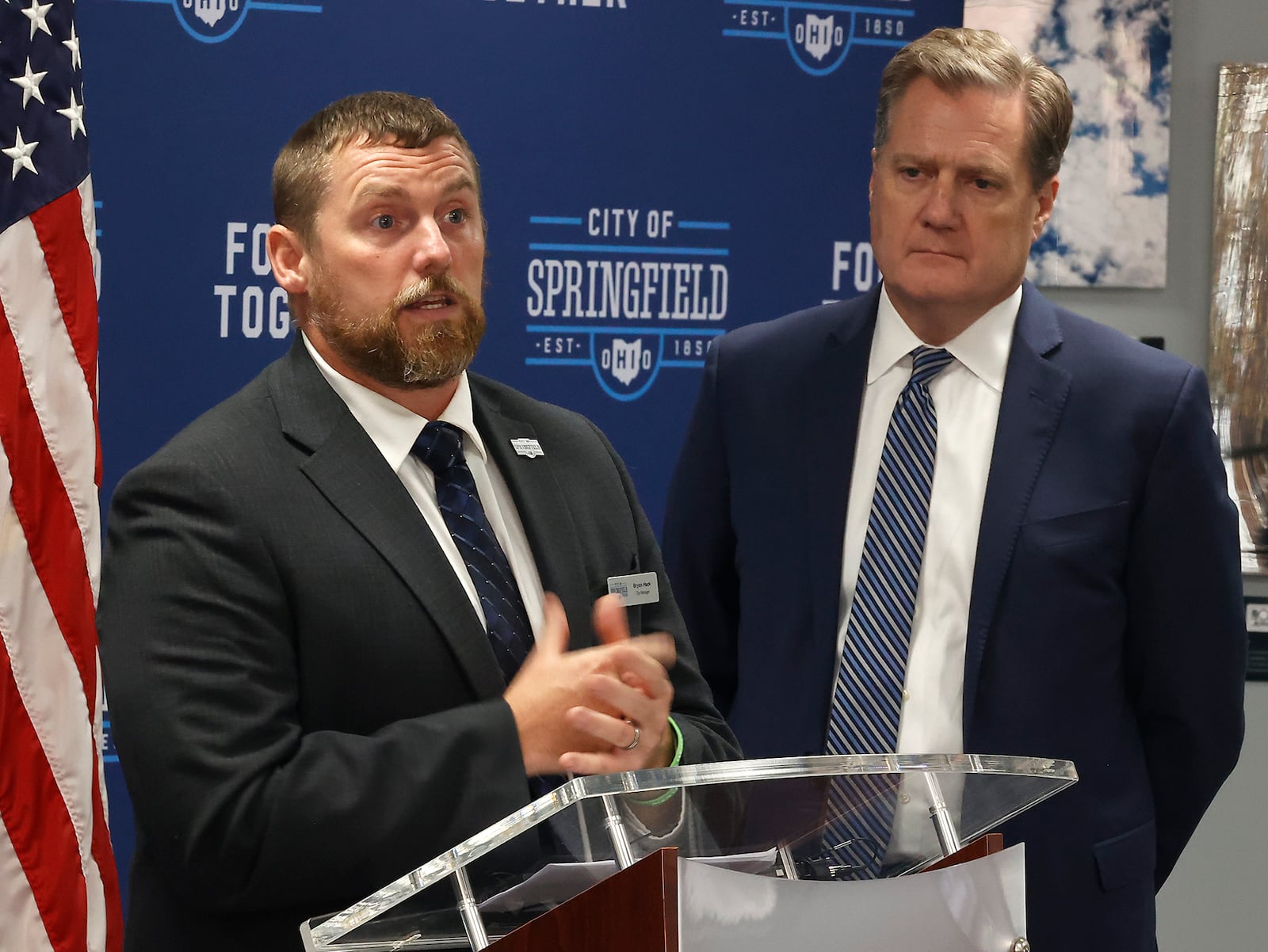 Springfield City Manager Bryan Heck speaks following a meeting with Congressman Mike Turner, in background, about the thousands of Haitian immigrants who have located in Springfield. BILL LACKEY/STAFF