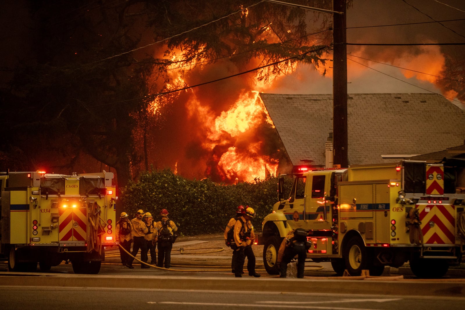 Firefighters battle the Eaton Fire Wednesday, Jan. 8, 2025 in Altadena, Calif. (AP Photo/Ethan Swope)