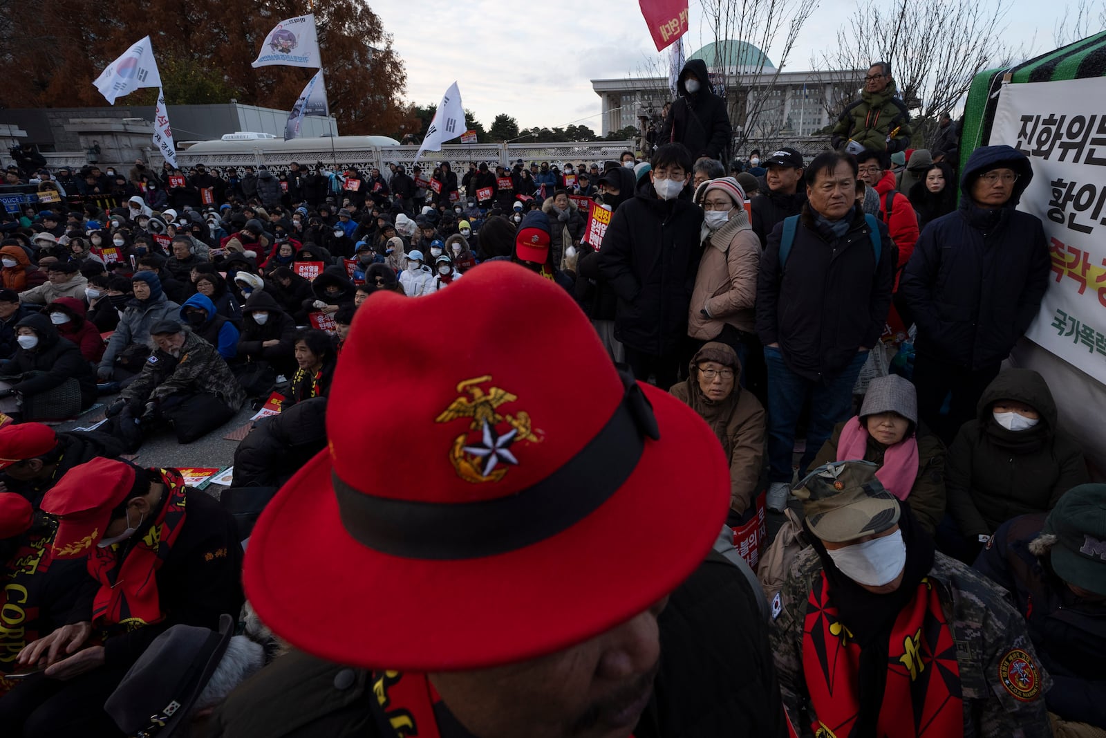 People gather outside the National Assembly during the voting for the impeachment of South Korean President Yoon Suk Yeol, following the President's short-lived martial law declaration in Seoul, South Korea, Saturday, Dec. 7, 2024. (AP Photo/Ng Han Guan)