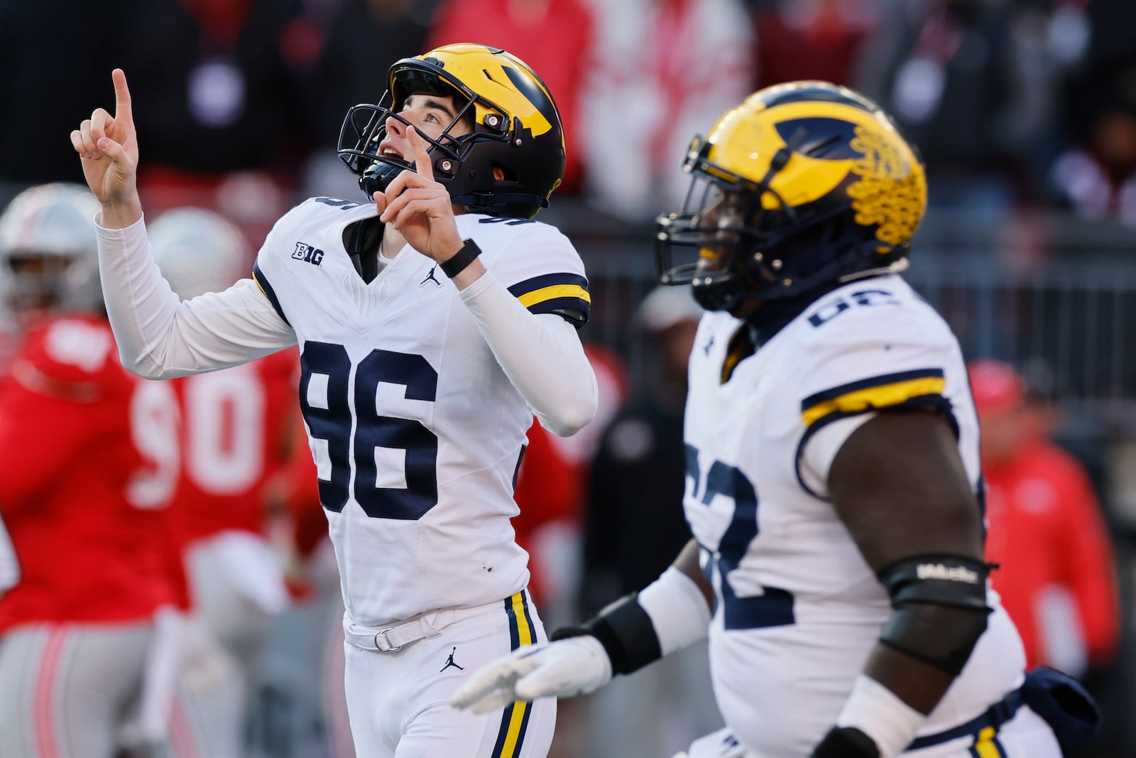 Michigan kicker Dominic Zvada, left, celebrates making the game-winning field goal against Ohio State during the second half of an NCAA college football game Saturday, Nov. 30, 2024, in Columbus, Ohio. (AP Photo/Jay LaPrete)