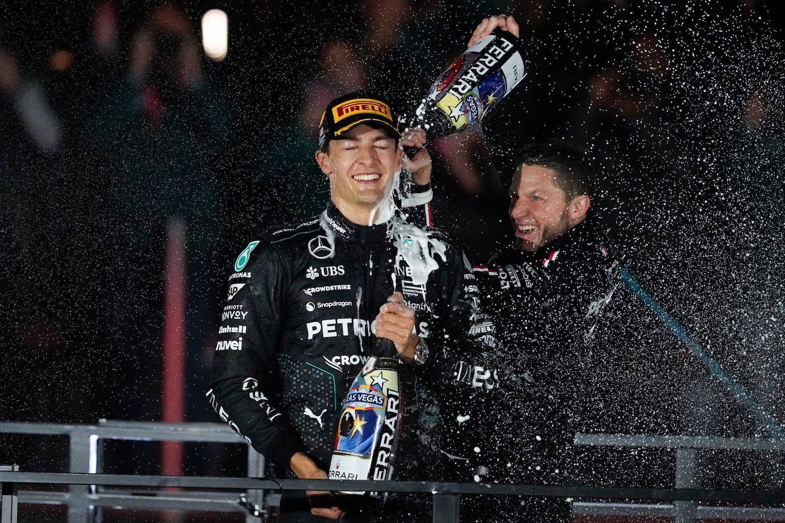 Mercedes driver George Russell, of Britain, celebrates on the podium after winning the F1 Las Vegas Grand Prix auto race, Sunday, Nov. 24, 2024, in Las Vegas. (AP Photo/Matt York)