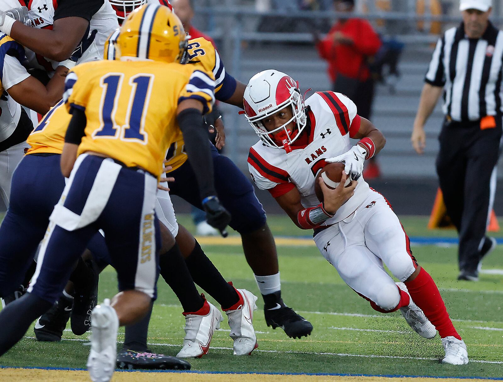 Trotwood's Deontai Gholson looks for an opening in the Springfield defense as he carries the ball. BILL LACKEY/STAFF