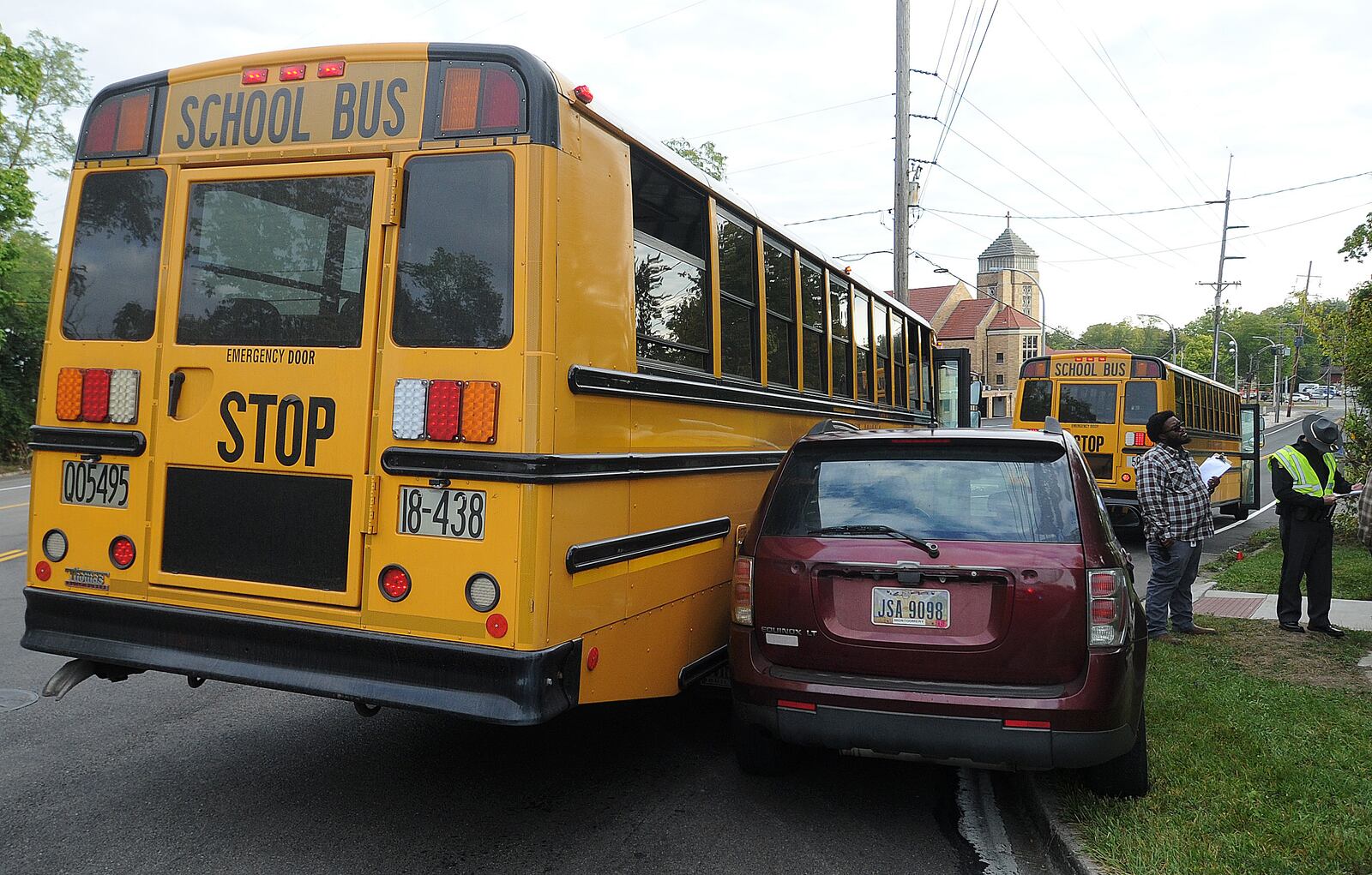 The Ohio State Highway Patrol is investigating a crash involving a Dayton Public School bus and an SUV near the Philadelphia Drive and Macy Street intersection in Harrison Twp. Tuesday, Sept. 19, 2023. One child from the bus was transported by medics. MARSHALL GORBY\STAFF