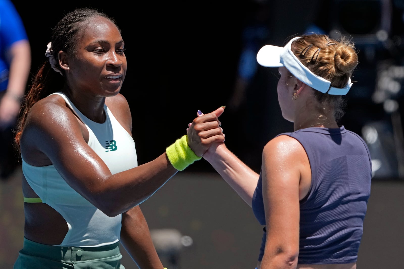 Coco Gauff, left, of the U.S. is congratulated by compatriot Sofia Kenin following their first round match at the Australian Open tennis championship in Melbourne, Australia, Monday, Jan. 13, 2025. (AP Photo/Asanka Brendon Ratnayake)