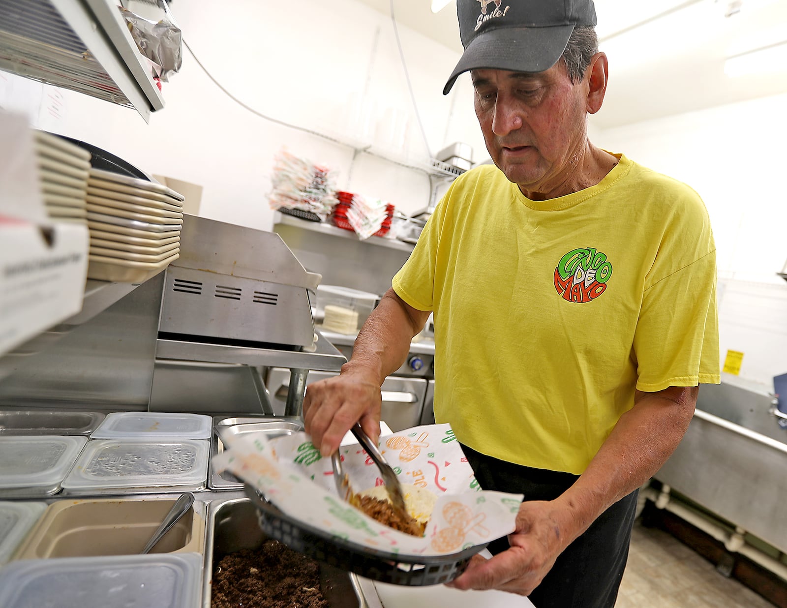 Felix Guerra, owner of Guerra's Krazy Taco, makes one of his famous tacos in the kitchen Wednesday, June 15, 2022. BILL LACKEY/STAFF