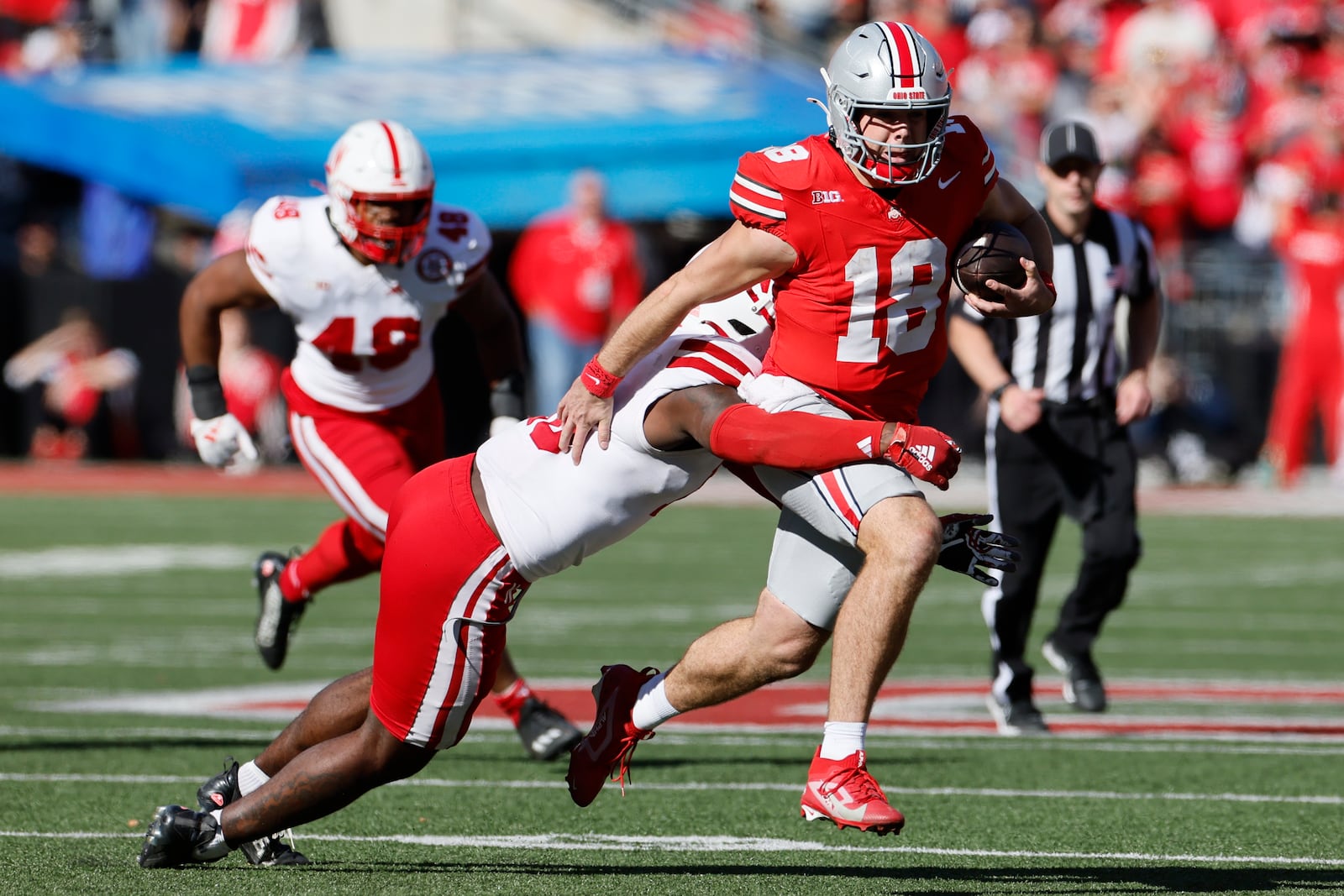 Nebraska defensive lineman Jimari Butler, left, tackles Ohio State quarterback Will Howard during the second half of an NCAA college football game Saturday, Oct. 26, 2024, in Columbus, Ohio. (AP Photo/Jay LaPrete)