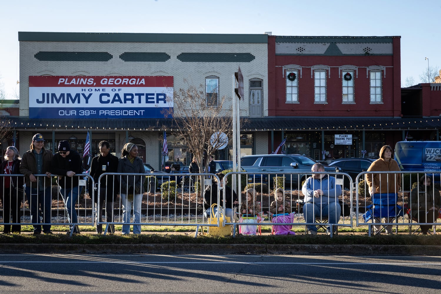 People gather near the main street of Plains, Ga., on Jan. 4, 225, before a funeral procession for President Jimmy Carter. (Dustin Chambers/The New York Times)