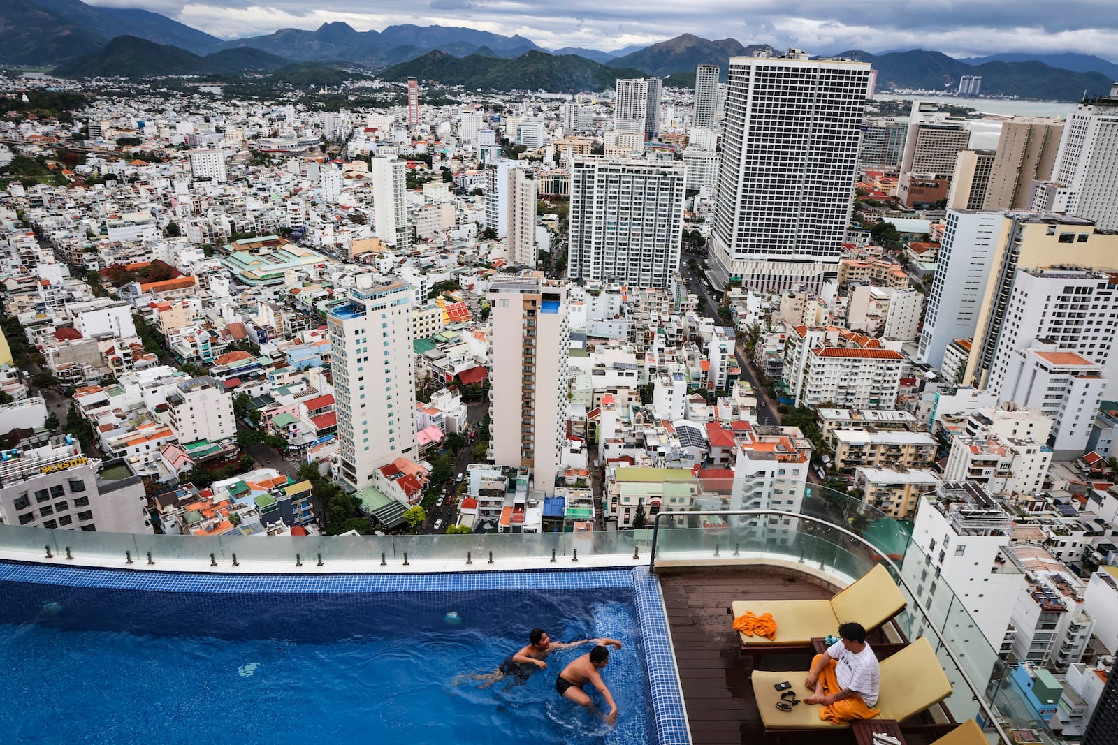 Tourists play in a pool at the Regalia Gold Hotel, in Nha Trang, Vietnam on Feb. 9, 2025. (AP Photo/Yannick Peterhans)