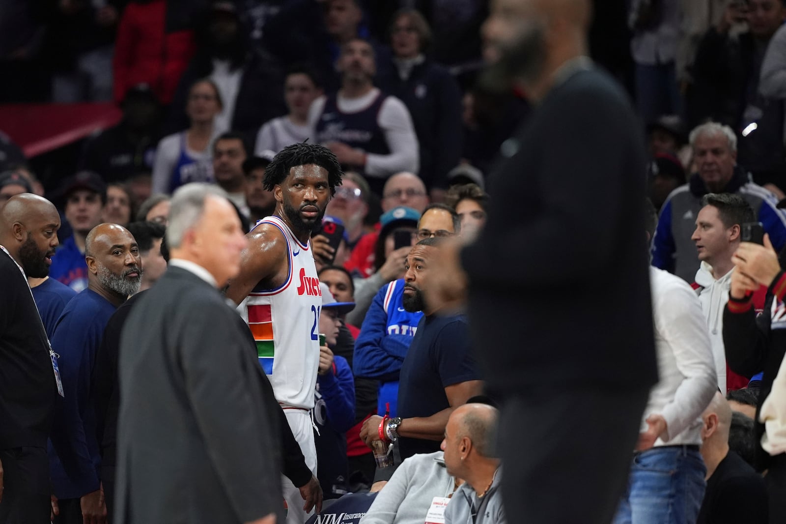 Philadelphia 76ers' Joel Embiid glares after being ejected by official Jenna Schroeder during the first half of an NBA basketball game against the San Antonio Spurs, Monday, Dec. 23, 2024, in Philadelphia. (AP Photo/Matt Slocum)