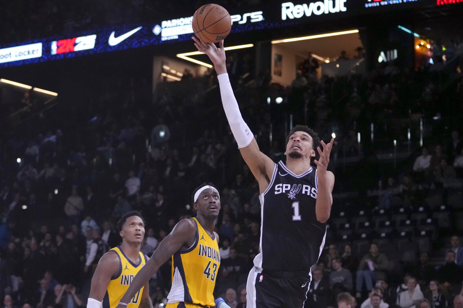 San Antonio Spurs center Victor Wembanyama (1) shoots against Indiana Pacers guard Bennedict Mathurin, bottom left, and forward Pascal Siakam (43) during the second half of a Paris Games 2025 NBA basketball game in Paris, Thursday, Jan. 23, 2025. (AP Photo/Thibault Camus)