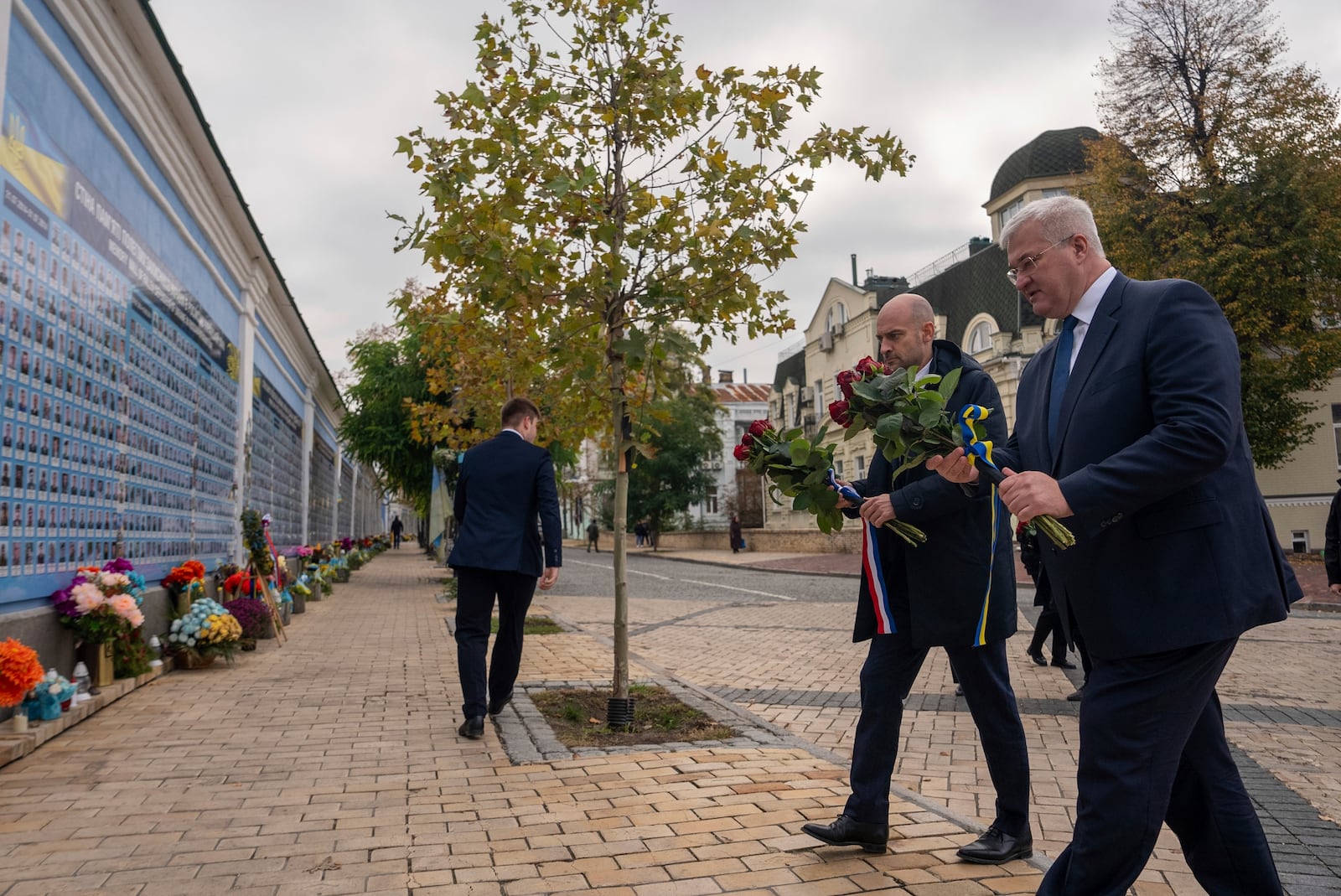 French Foreign Minister Jean-Noel Barrot and Ukrainian Minister of Foreign Affairs Andrii Sybiha lay flowers at the memorial for Ukrainian killed soldiers inin central Kyiv, Ukraine, Saturday, Oct. 19, 2024. (AP Photo/Alex Babenko)