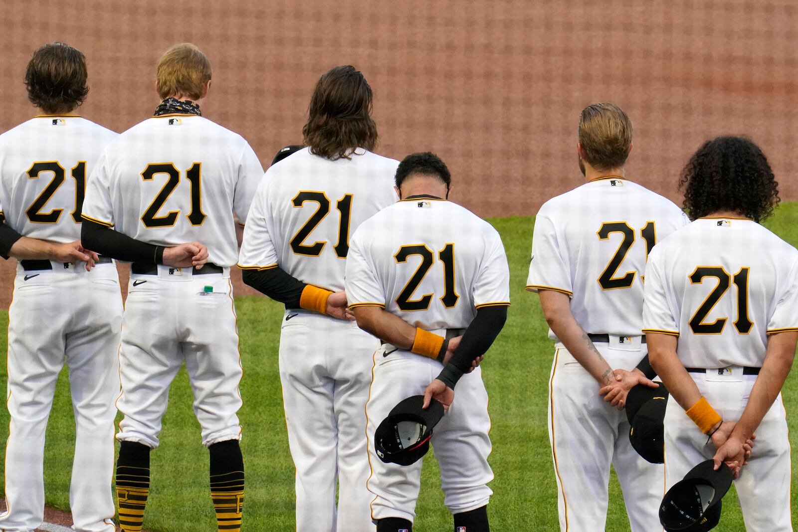 Pittsburgh Pirates, all wearing Roberto Clemente's No. 21 for Roberto Clemente Day, watch a tribute to the Pirates Hall of Fame right fielder before the team's baseball game against the Chicago White Sox in Pittsburgh, Wednesday, Sept. 9, 2020. (AP Photo/Gene J. Puskar)