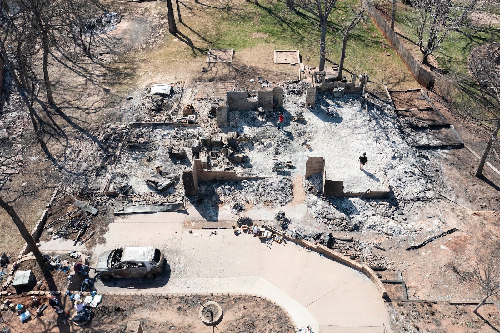 An aerial view of Andrine Shufran's burned home in the Hidden Oaks neighborhood in Stillwater, Okla., Monday, March 17, 2025, after wildfires burned through the area Friday. (AP Photo/Alonzo Adams)