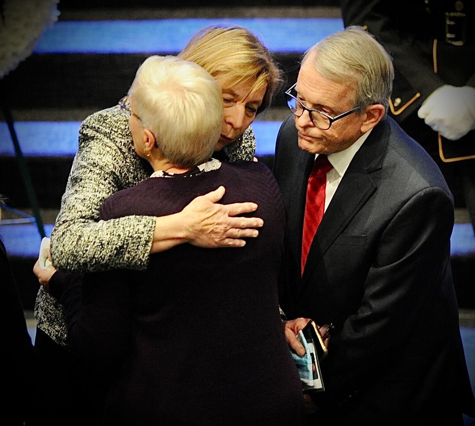 Gov. Mike DeWine and Fran DeWine hugged the wife of Greene County Sheriff Gene Fischer at Fischer's funeral in Cedarville on Wednesday, Nov. 24, 2021. MARSHALL GORBY / STAFF