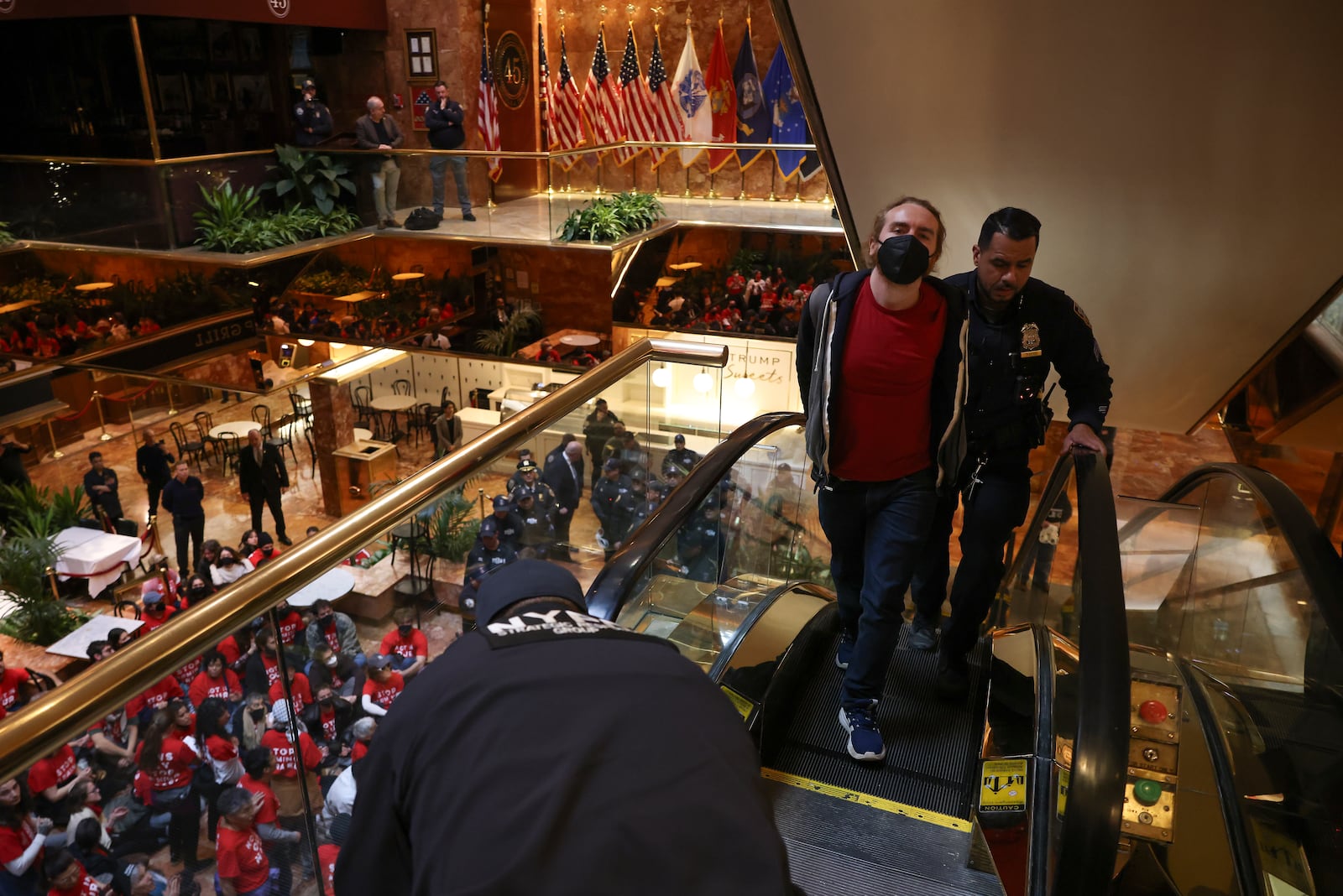 A demonstrator from the group, Jewish Voice for Peace, who protested inside Trump Tower in support of Columbia graduate student Mahmoud Khalil is escorted out by New York Police officers after being arrested, Thursday, March 13, 2025, in New York. (AP Photo/Yuki Iwamura)