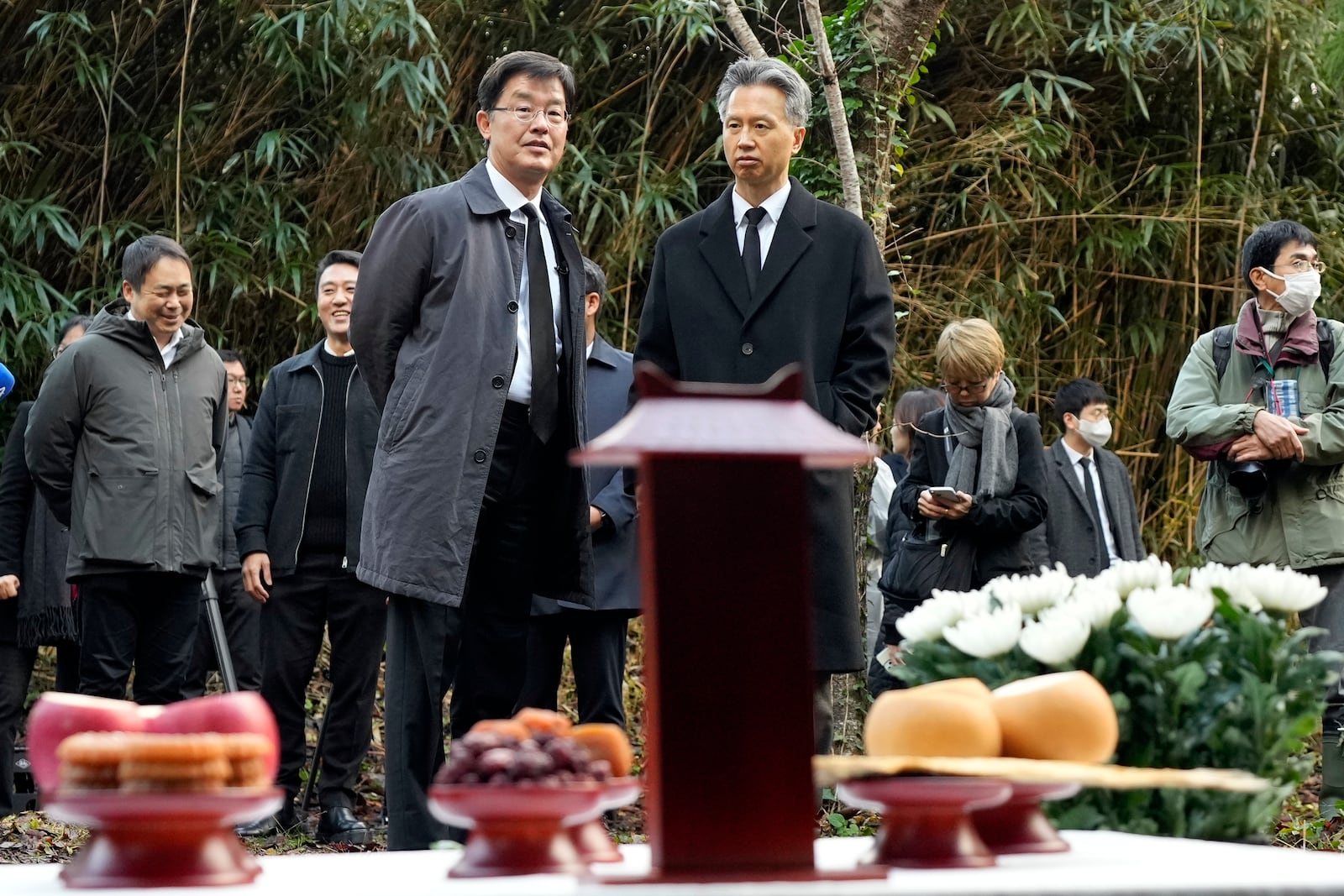 South Korean Ambassador to Japan Park Cheol-hee, front left, looks at a memorial service at the site of former Fourth Souai Dormitory for the mine workers from the Korean Peninsula, in Sado, Niigata prefecture, Japan, Monday, Nov. 25, 2024. (AP Photo/Eugene Hoshiko)