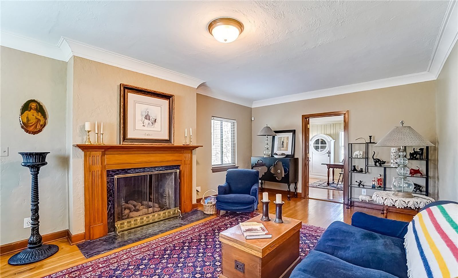 The living room has hardwood floors and a fireplace with wood mantel. An exterior door leads to the sunroom.