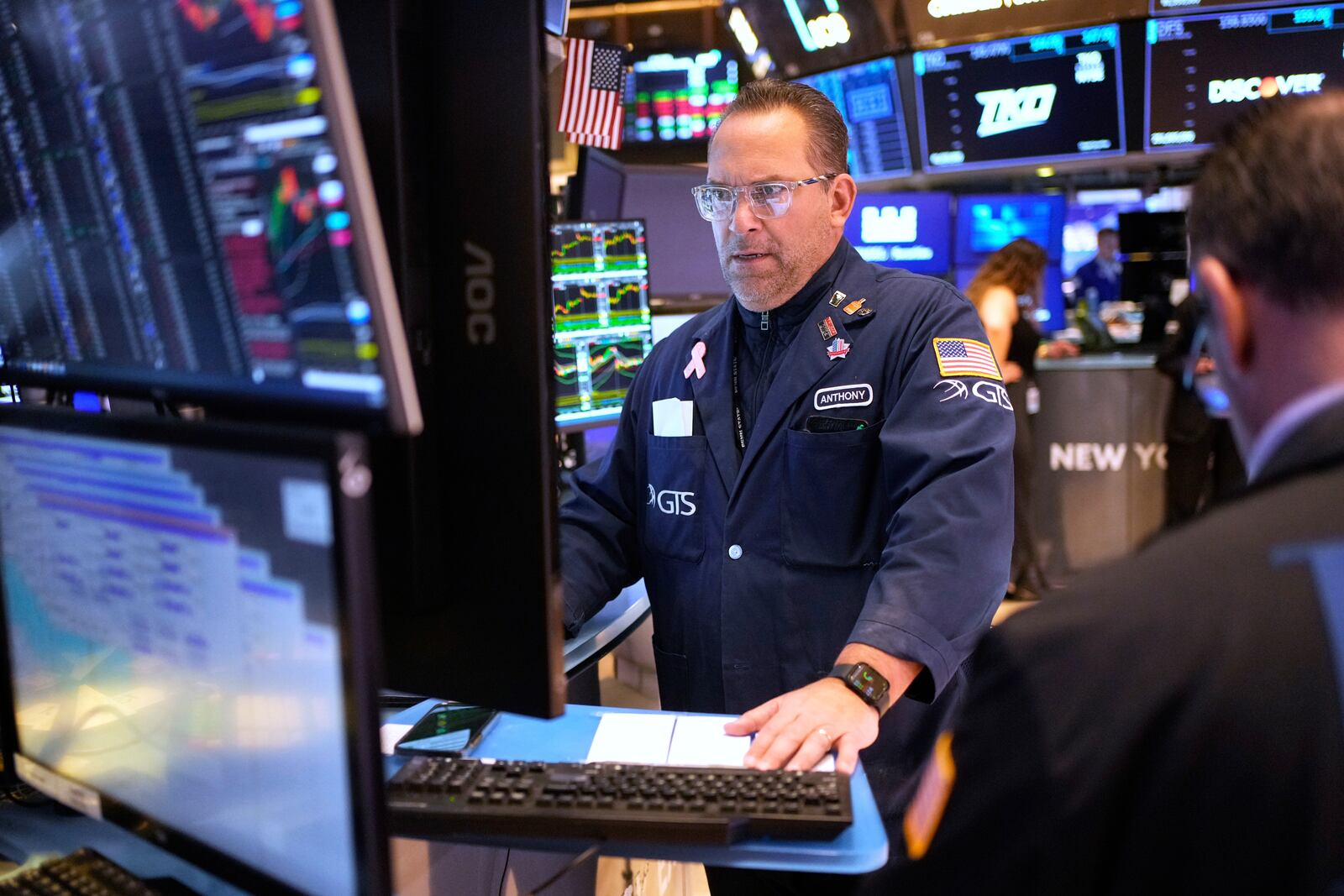 People work on the floor at the New York Stock Exchange in New York, Wednesday, March 19, 2025. (AP Photo/Seth Wenig)