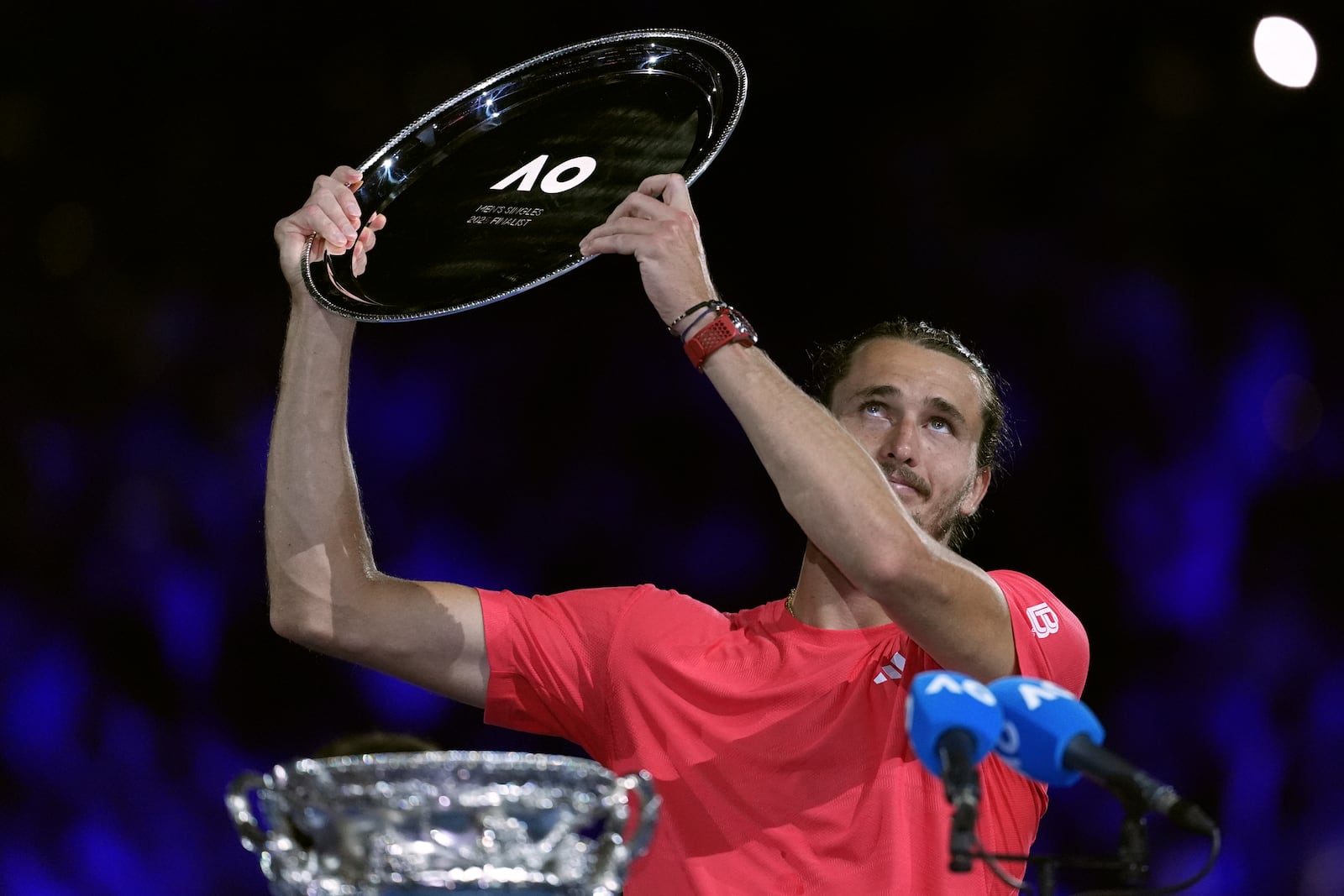 Alexander Zverev of Germany holds up his trophy after losing the men's singles final to Jannik Sinner of Italy at the Australian Open tennis championship in Melbourne, Australia, Sunday, Jan. 26, 2025. (AP Photo/Ng Han Guan)