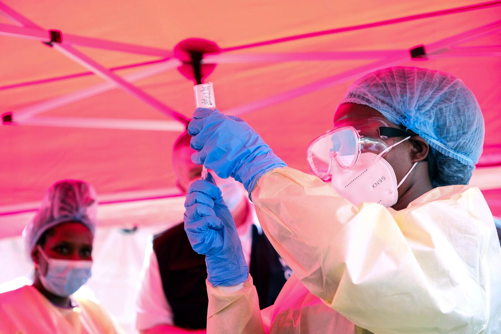 A health worker prepares to administer a vial of a vaccine against the Sudan strain of Ebola, during a trial, at Mulago Referral Hospital, in Kampala, Uganda Monday, Feb. 3, 2025. (AP Photo/Hajarah Nalwadda)