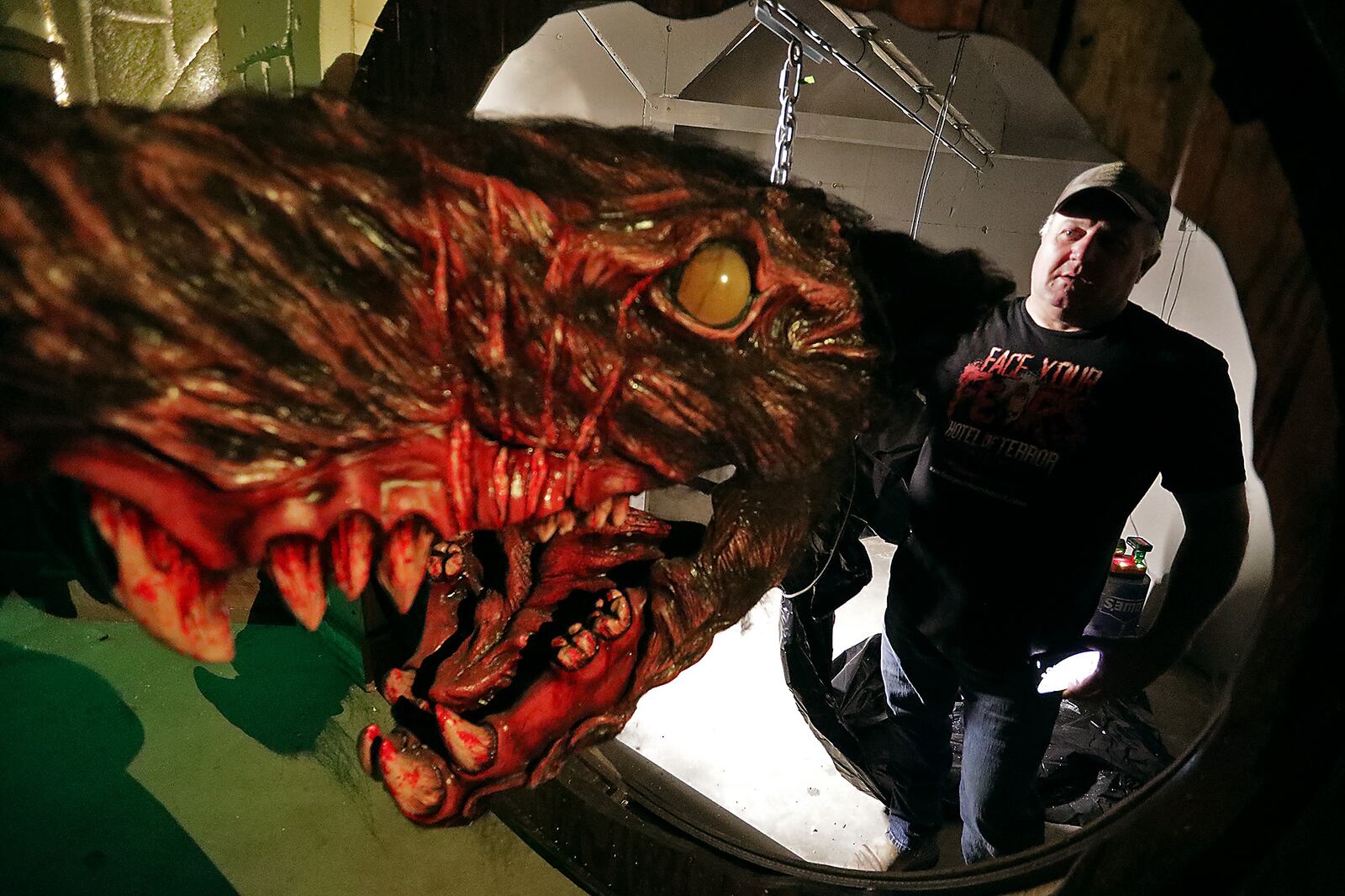 Fred Messaros pushes a giant monster rat through the hole is will come through when the Face Your Fears Hotel of Terror opens for the season. BILL LACKEY/STAFF