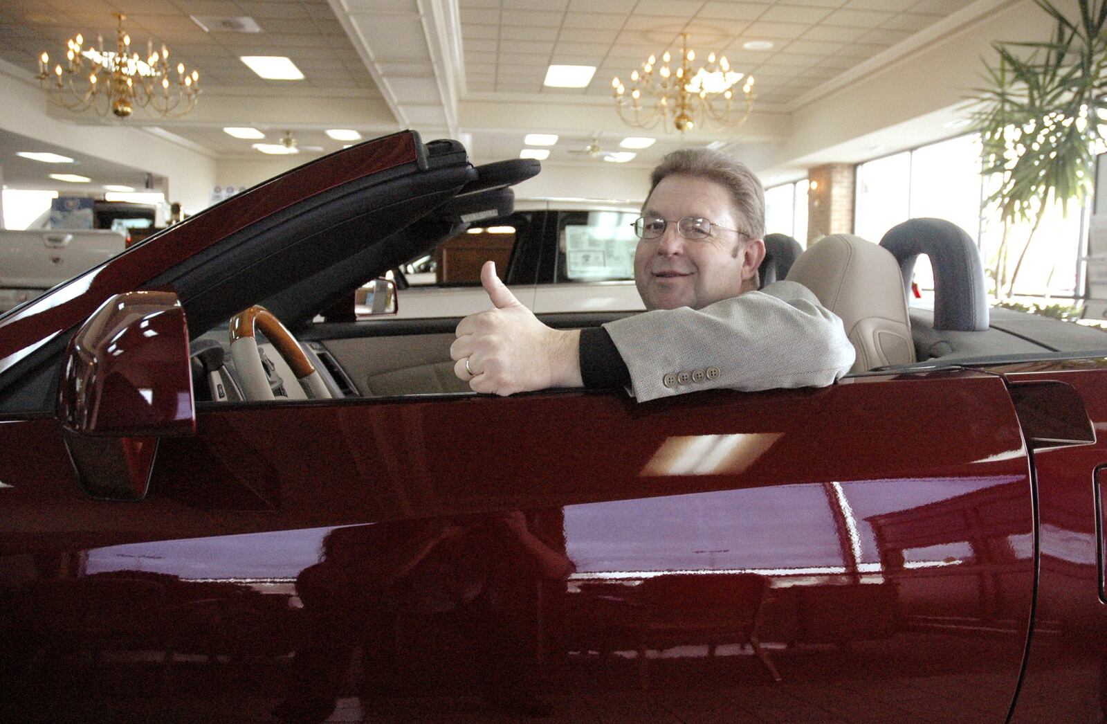 A 2007 photo of Jeff Schmitt in one of the new Cadillacs at Jeff Schmitt Cadillac in Beavercreek. FILE