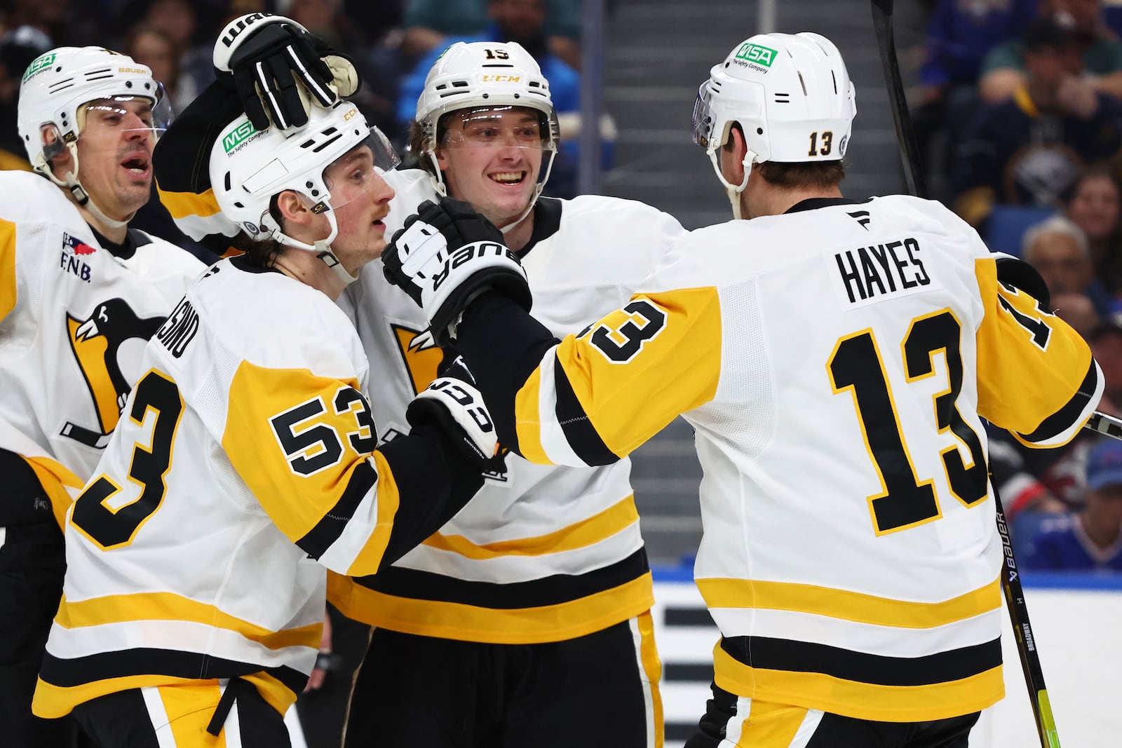 Pittsburgh Penguins center Cody Glass (19) celebrates his goal with forward Philip Tomasino (53) and right wing Kevin Hayes (13) during the second period of an NHL hockey game against the Buffalo Sabres Friday, Jan. 17, 2025, in Buffalo, N.Y. (AP Photo/Jeffrey T. Barnes)