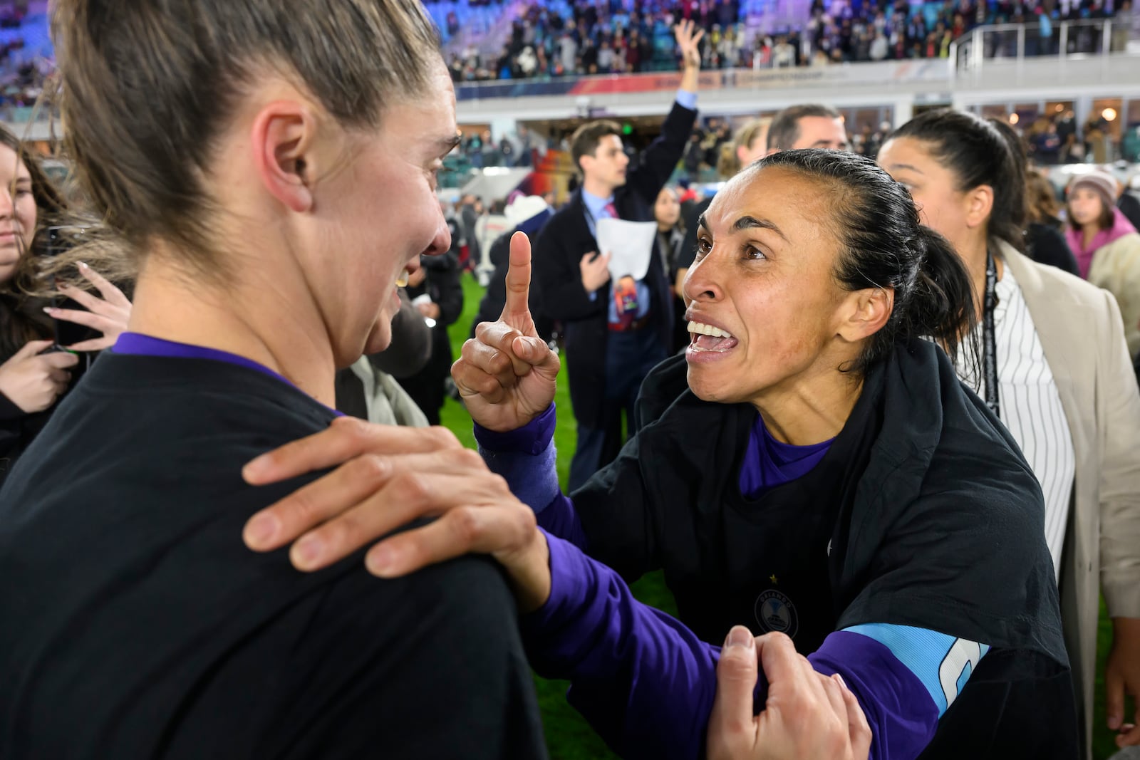 Orlando Pride forward Marta, right, celebrates with midfielder Morgan Gautrat, left, after they defeated the Washington Spirit in the NWSL championship soccer game at CPKC Stadium, Saturday, Nov. 23, 2024, in Kansas City, Mo. (AP Photo/Reed Hoffmann)