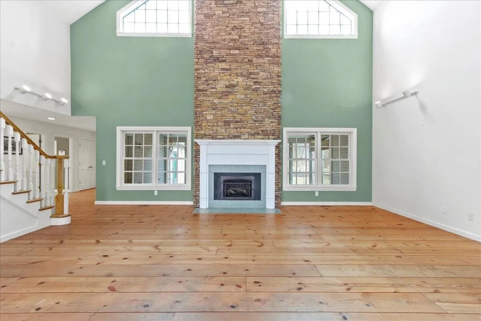 The two-story great room has a gas stone fireplace with tile hearth. 