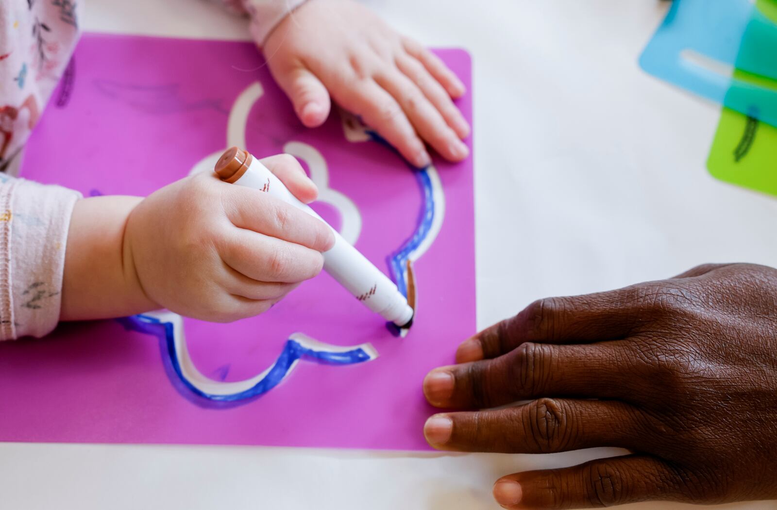 Teacher Jacob Sibiti, right, helps a student in the pre-k class at Mini University, a child development center on the Miami University campus,  Thursday, April 6, 2023 in Oxford. NICK GRAHAM/STAFF