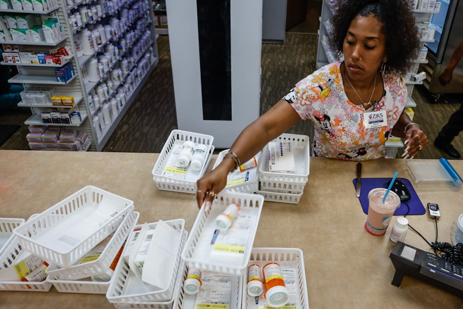 Pharmacy technician for Ziks Pharmacy Jasmine Woodard preps medications at the West Third Street location on Monday, July 1, 2024. The closing of many pharmacies around Dayton is making it harder for residents to get their medications and harder for the pharmacies left to meet growing demands. JIM NOELKER/STAFF