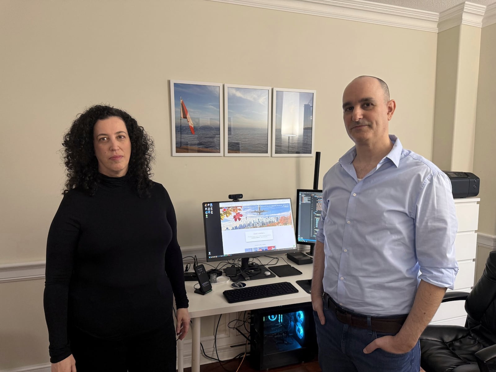 Michal Harel and her husband Avital Epstein show the website they set up to help Israelis navigate a move to Canada in Oakville, Ontario, Canada, Wednesday, Dec. 4, 2024. (AP Photo/Rob Gillies)