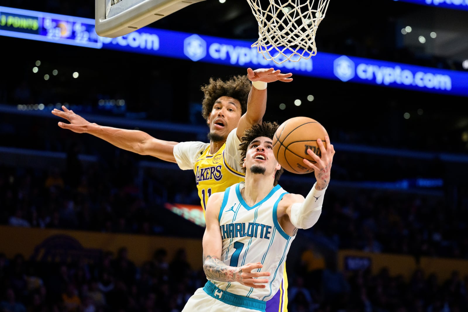 Charlotte Hornets guard LaMelo Ball (1) shoots the ball while under pressure from Los Angeles Lakers center Jaxson Hayes during the first half of an NBA basketball game Wednesday, Feb. 19, 2025, in Los Angeles. (AP Photo/William Liang)